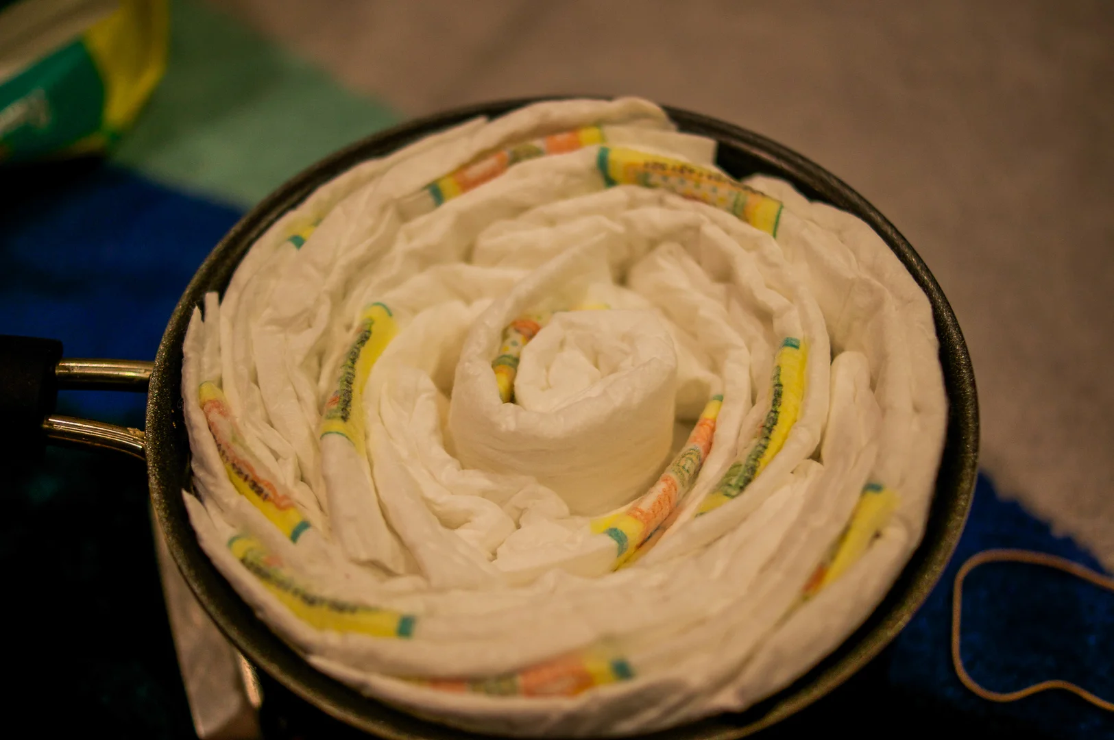 The center of the diaper cake can be an empty toilet paper roll or just a rolled up diaper. 