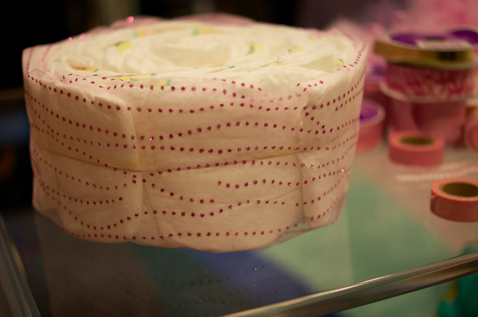 Mesh tulle wrapped around the diaper cake. I kept the rubber band in place.