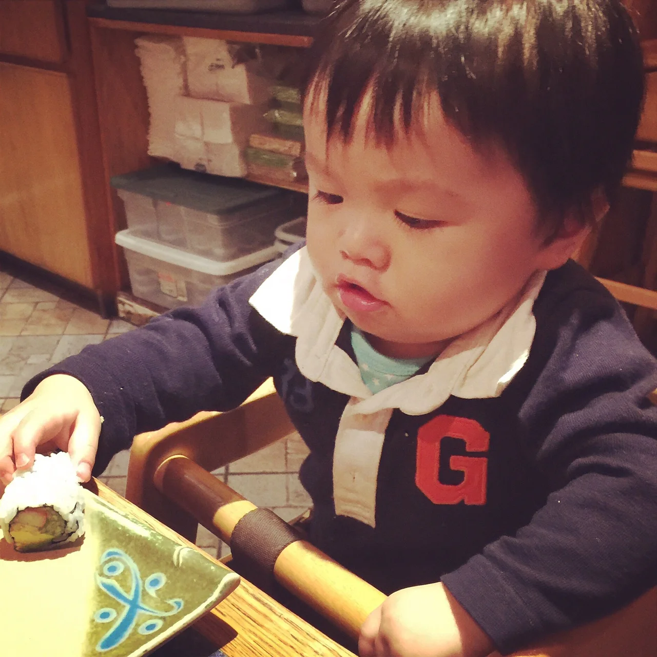 Phil reaching for a piece of California roll at one of our favorite family sushi restaurants in NYC. Does he look like a girl, by the way? Someone said to us, "Oh what a cute girl she is! G for girl, right?" Um... 