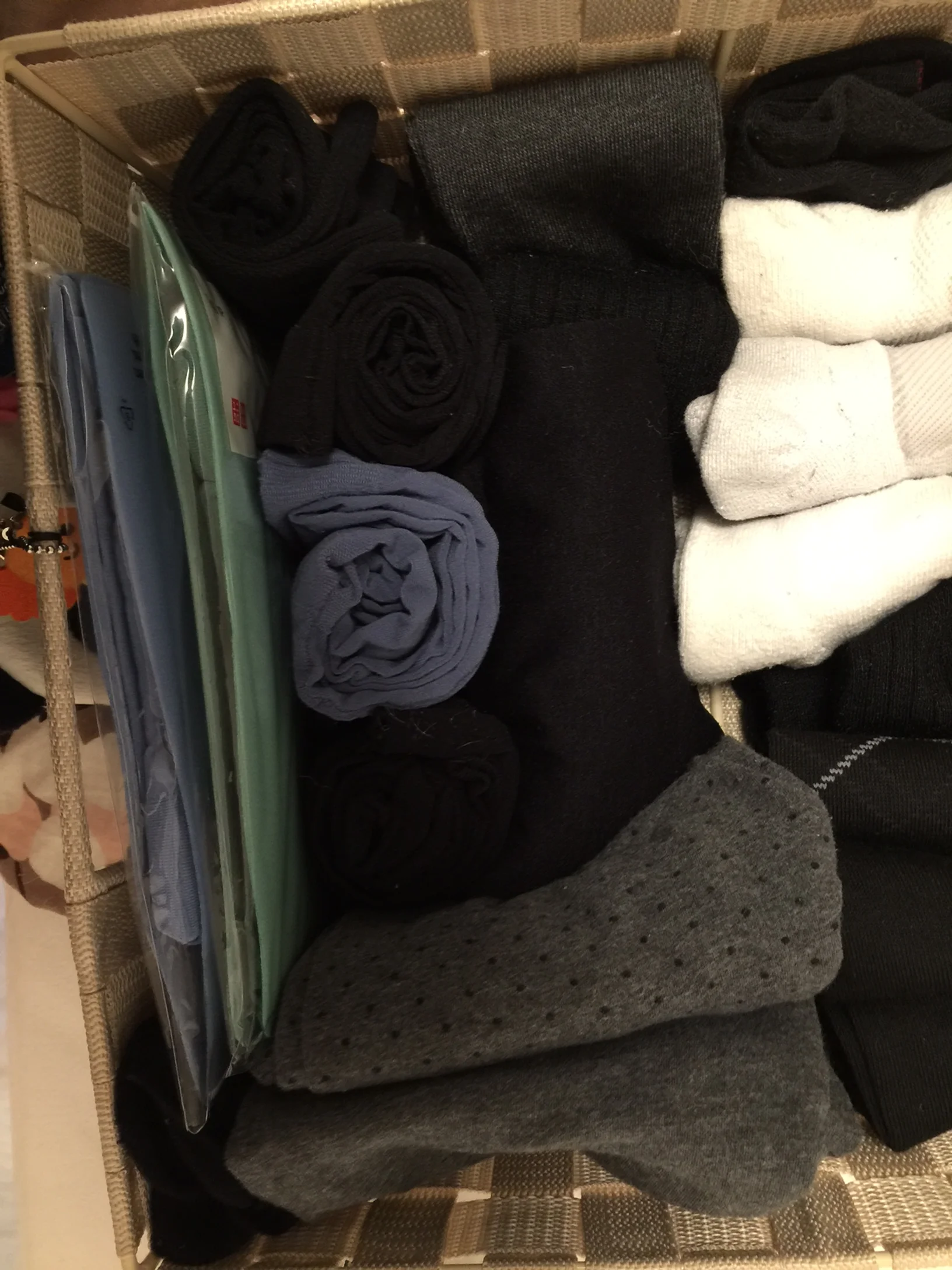 Stockings rolled into sushi shapes. Shorter socks folded into rectangles (just fold them onto each other: two folds for short socks, three folds for longer socks)