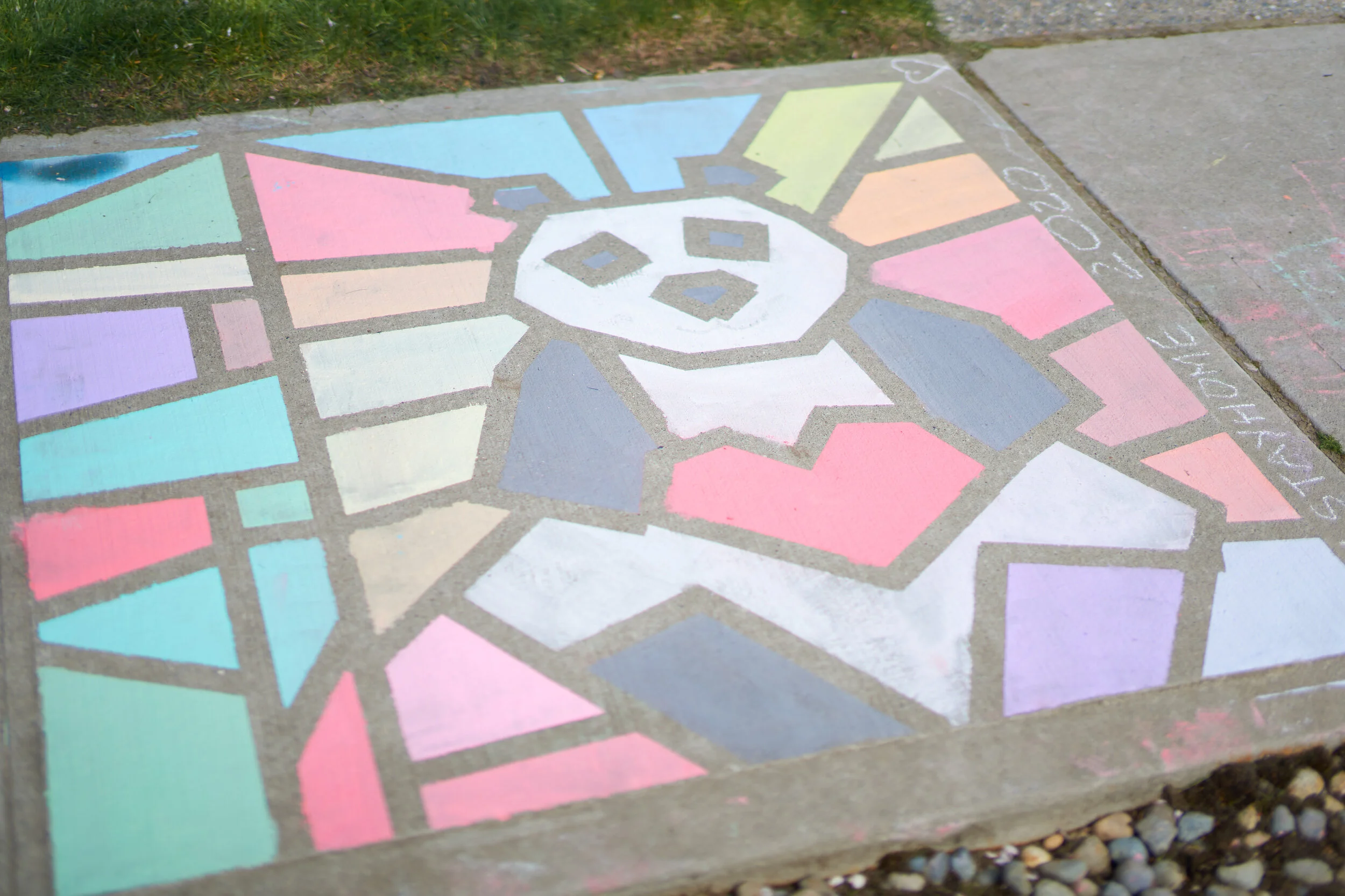 We made a stained glass sidewalk chalk art and think you should too! (Great homeschool activity.)