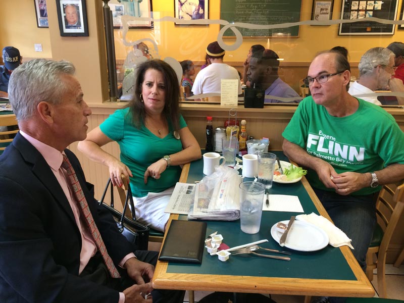 Scott Krugman (left) asks Eugene Flinn about his plans should he become mayor again as Flinn's wife Alexandra looks on.