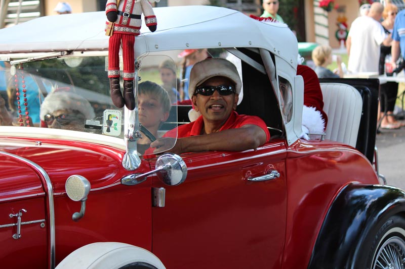 Stanley Kowlessar with santa in the back and Mrs. Mangowood, rose van patten, in the passenger seat