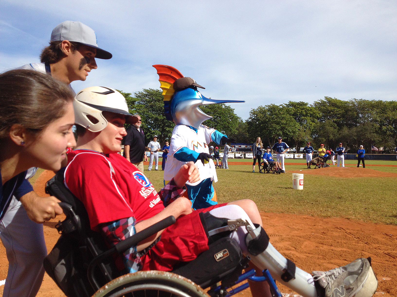 Cameron Honey gets a hit as Billy the Marlin cheers him on in the Miracle League game.