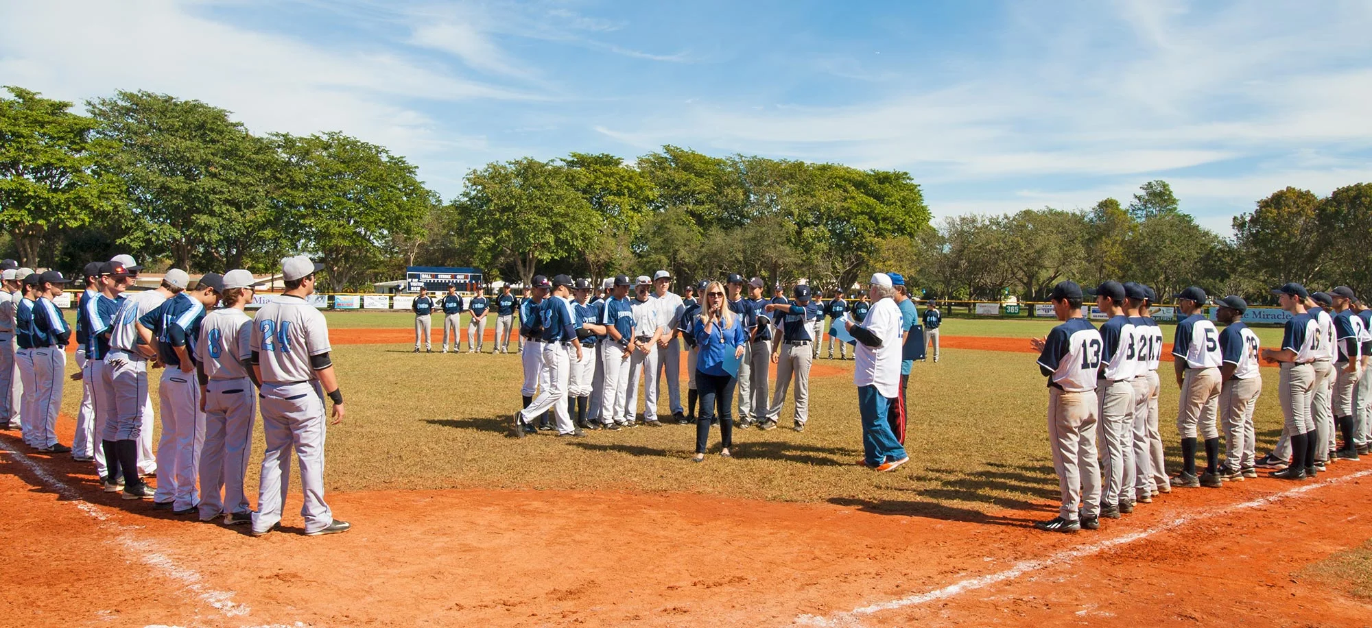 Palmetto Bay councilwoman Karyn Cunningham hands our awards to deserving players after the Miracle League baseball game.