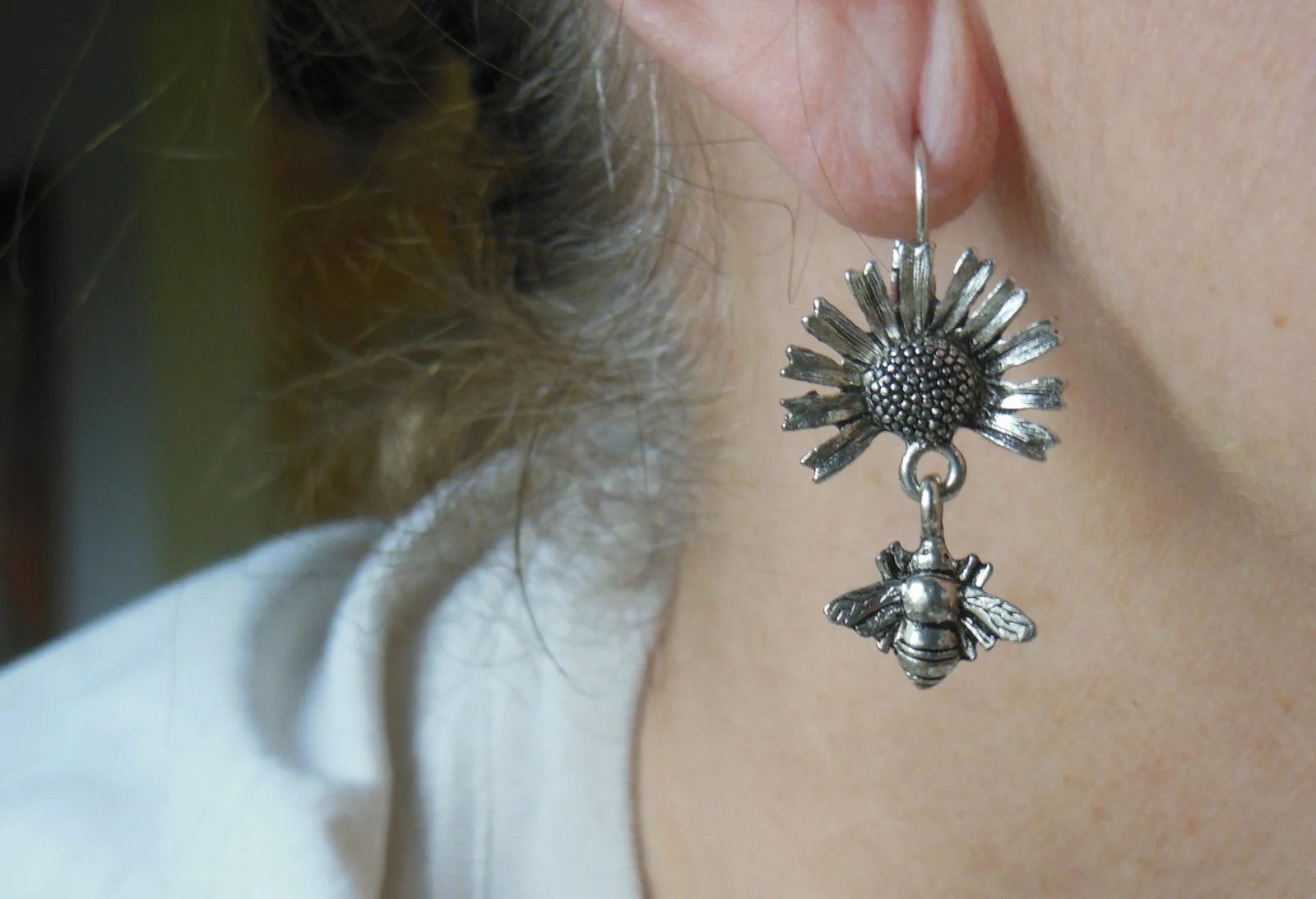 Bees on Flower Earrings in ear.jpg