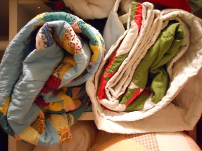 STORE QUILTS ROLLED UP LIKE SLEEPING BAGS IN COTTON PILLOW CASES