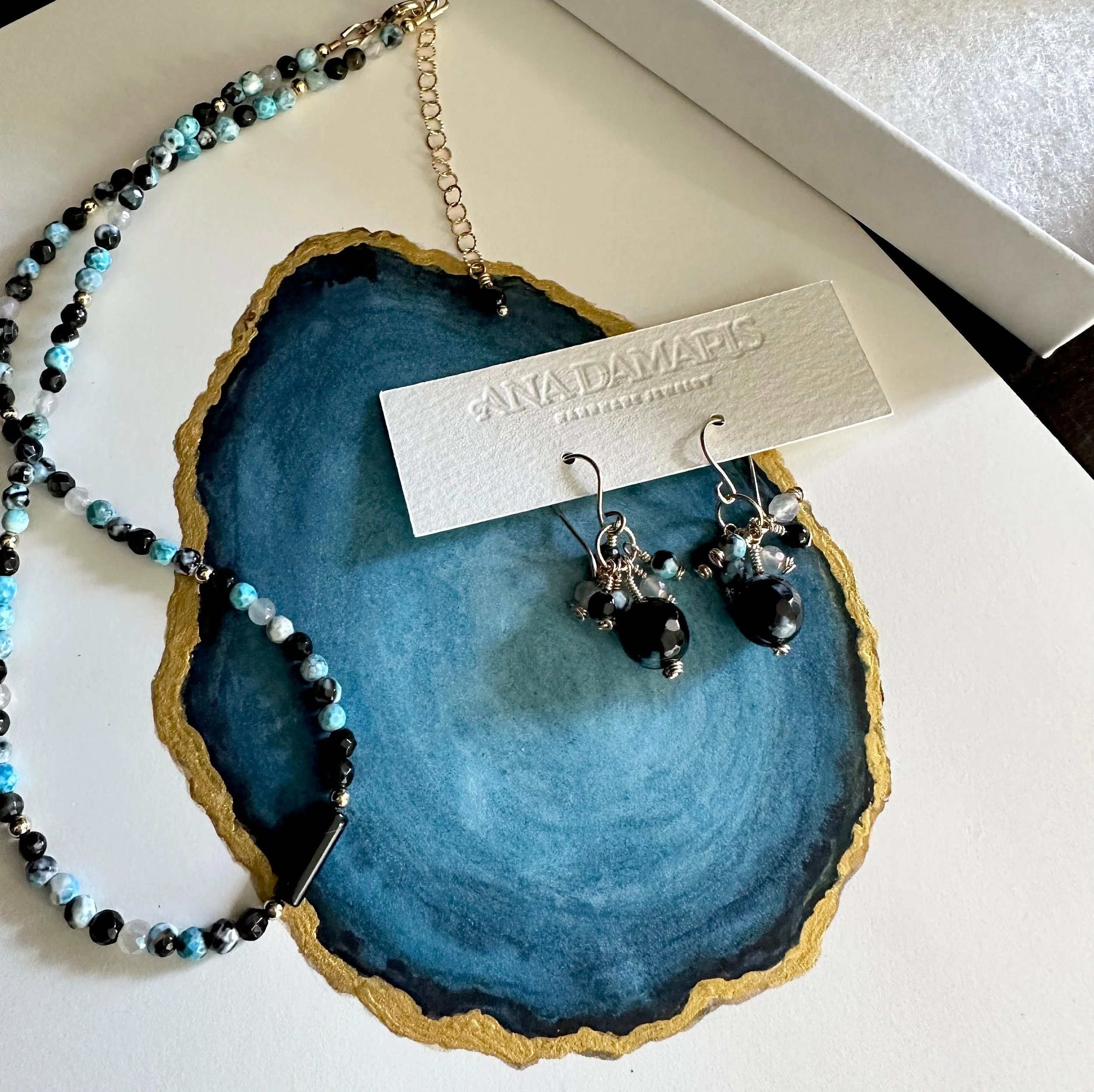 fire agate blue black beaded gemstone necklace display