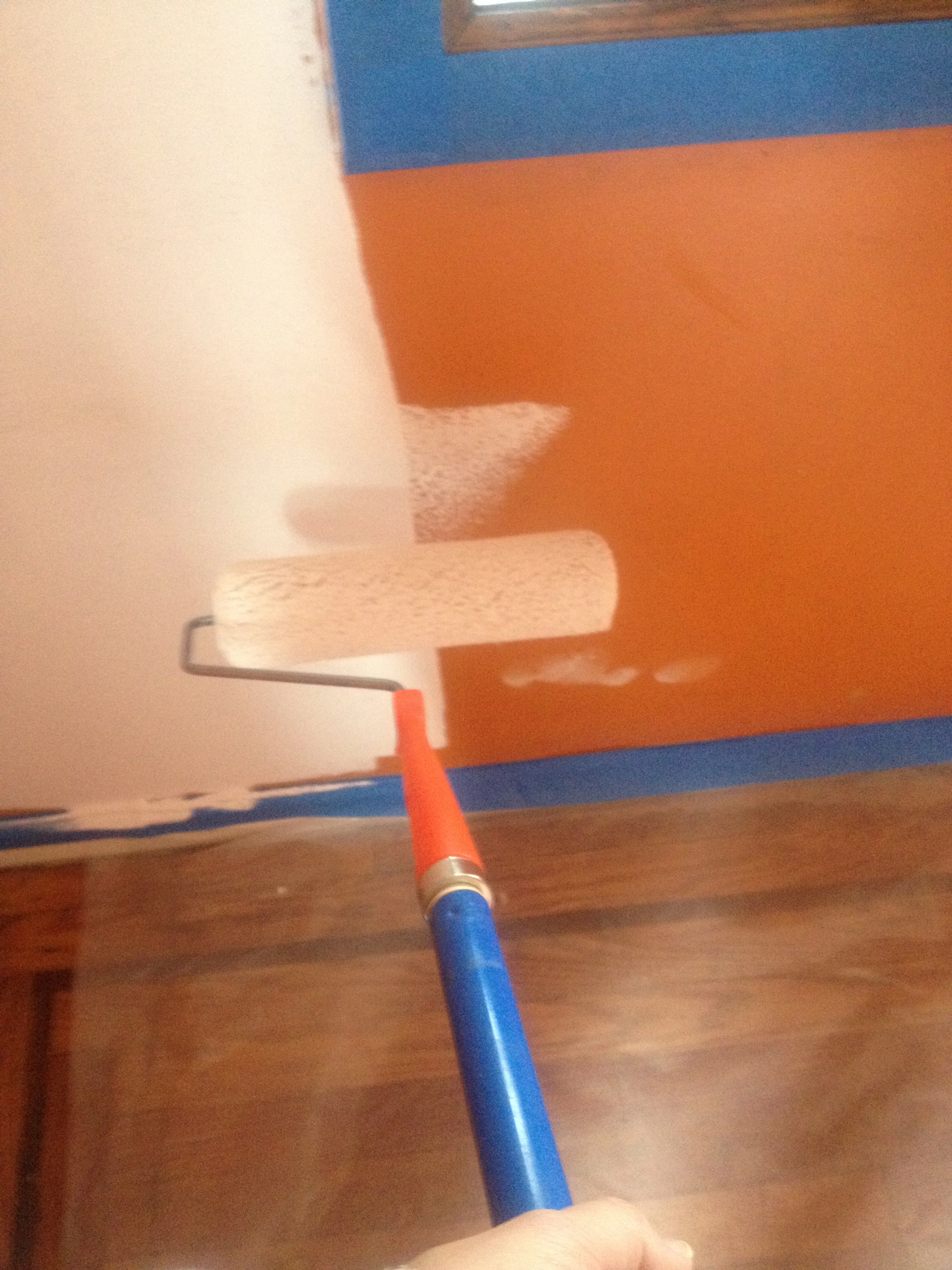 Painting over that strong orange paint (thank goodness for painter's tape)