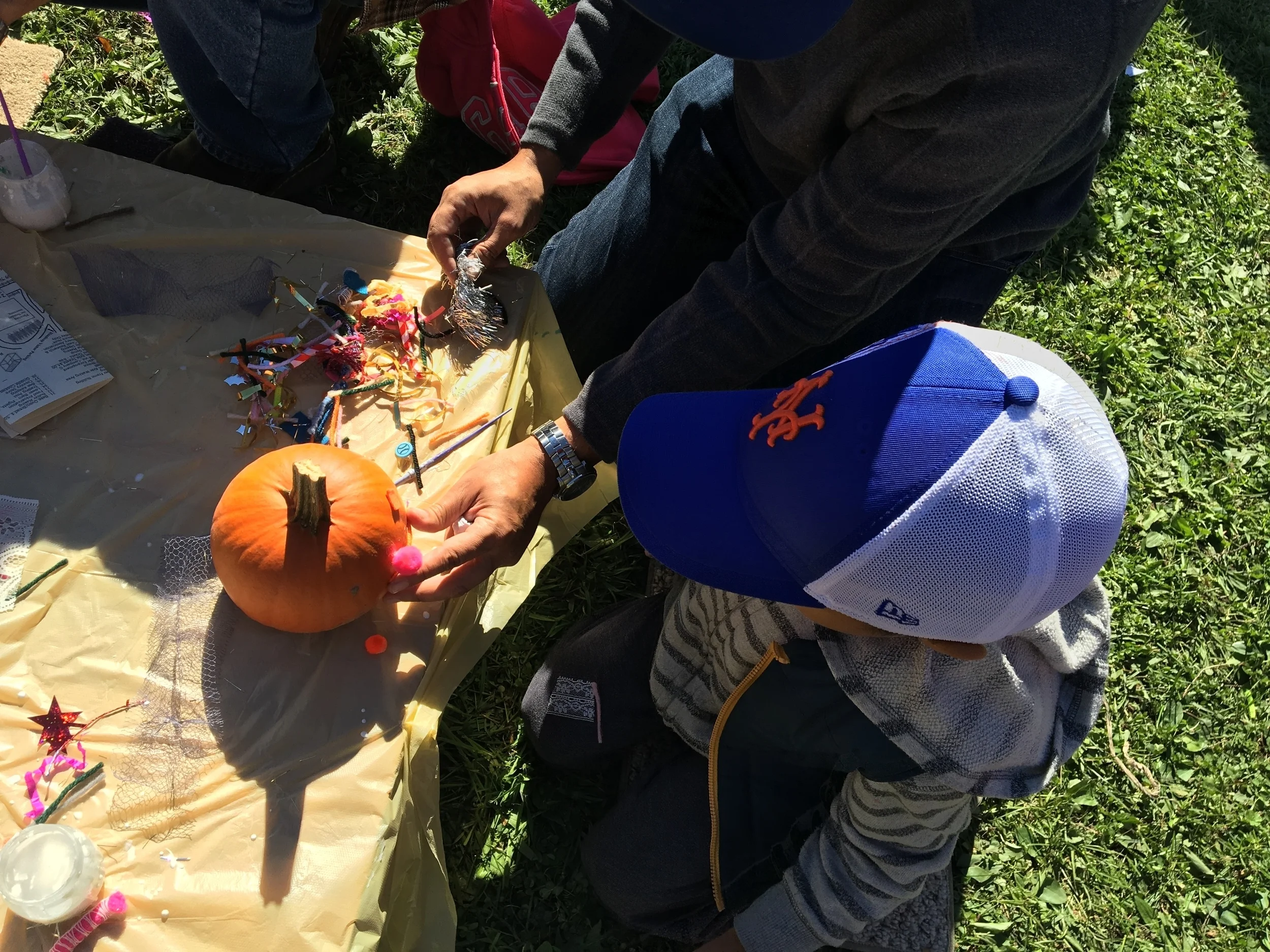 My husband and son decorating a pumpkin.
