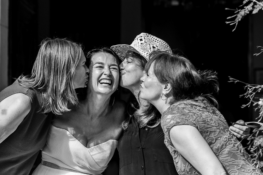 the bride and her best friends giving her a kiss