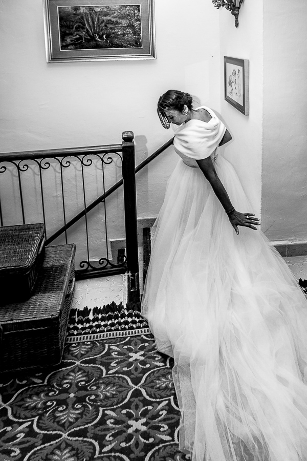 bride going down the stairs ready first look