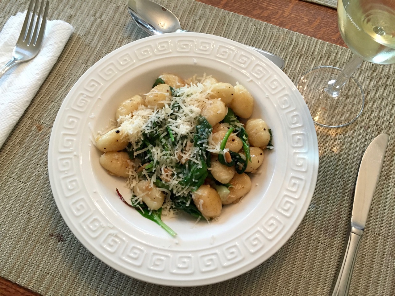 Gnocchi with pine nuts and spinach, garnished with Parmesan cheese. Currently my daughter's favourite dish.