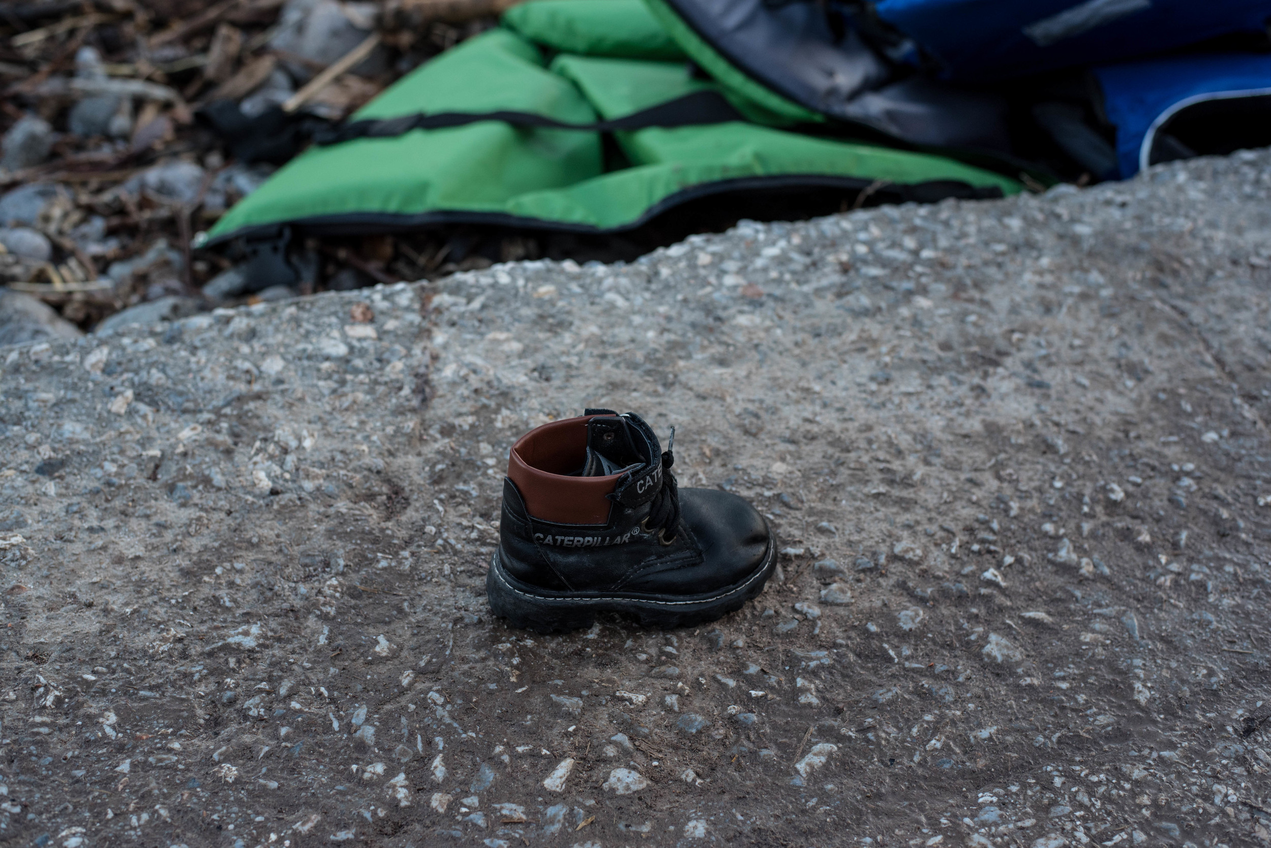 A child's boot left behind. Water-logged shoes are usually the first possessions cast aside.