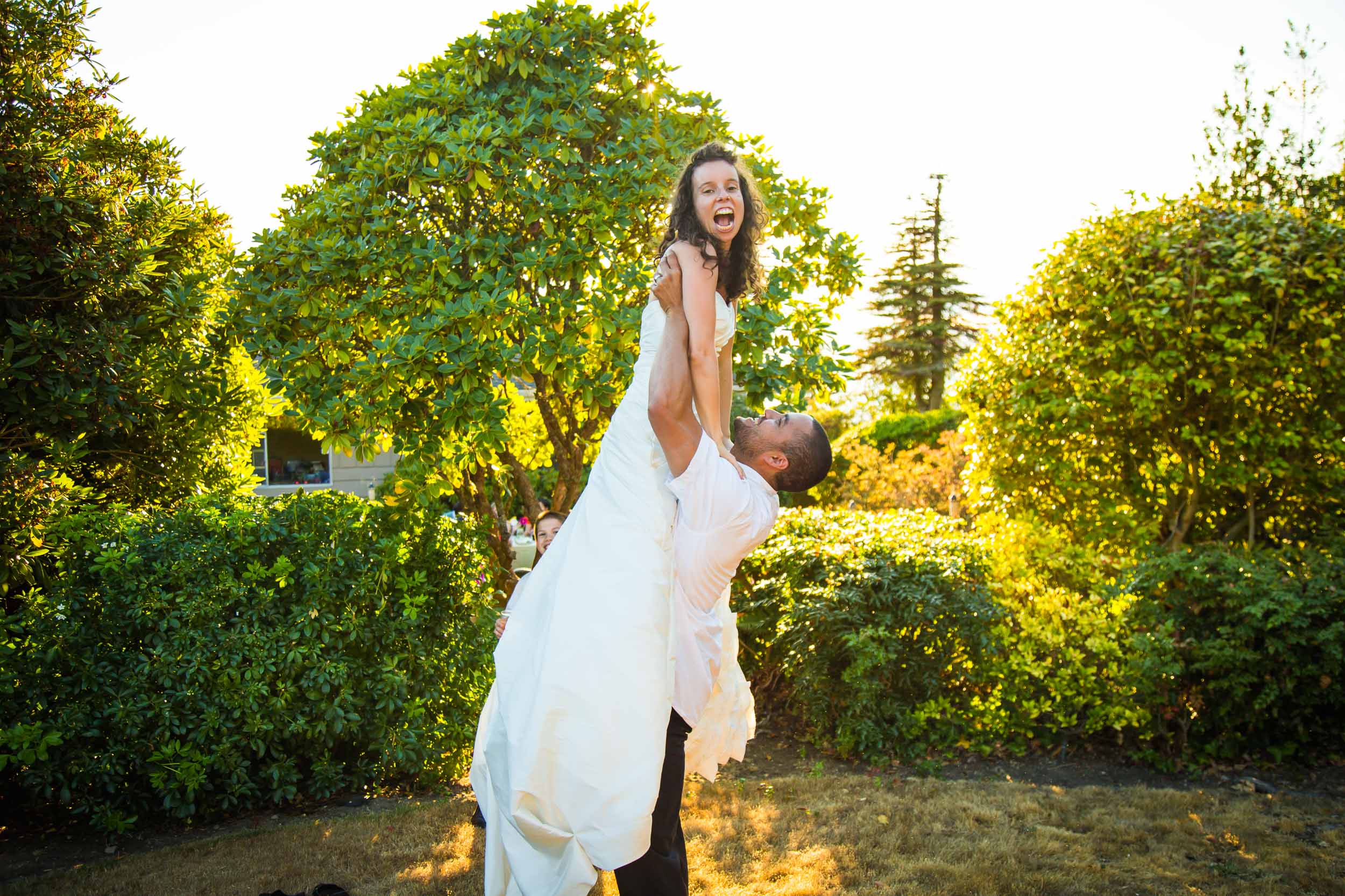 Seattle Wedding Photographer | By G. Lin Photography | Groom holding up bride in garden wedding