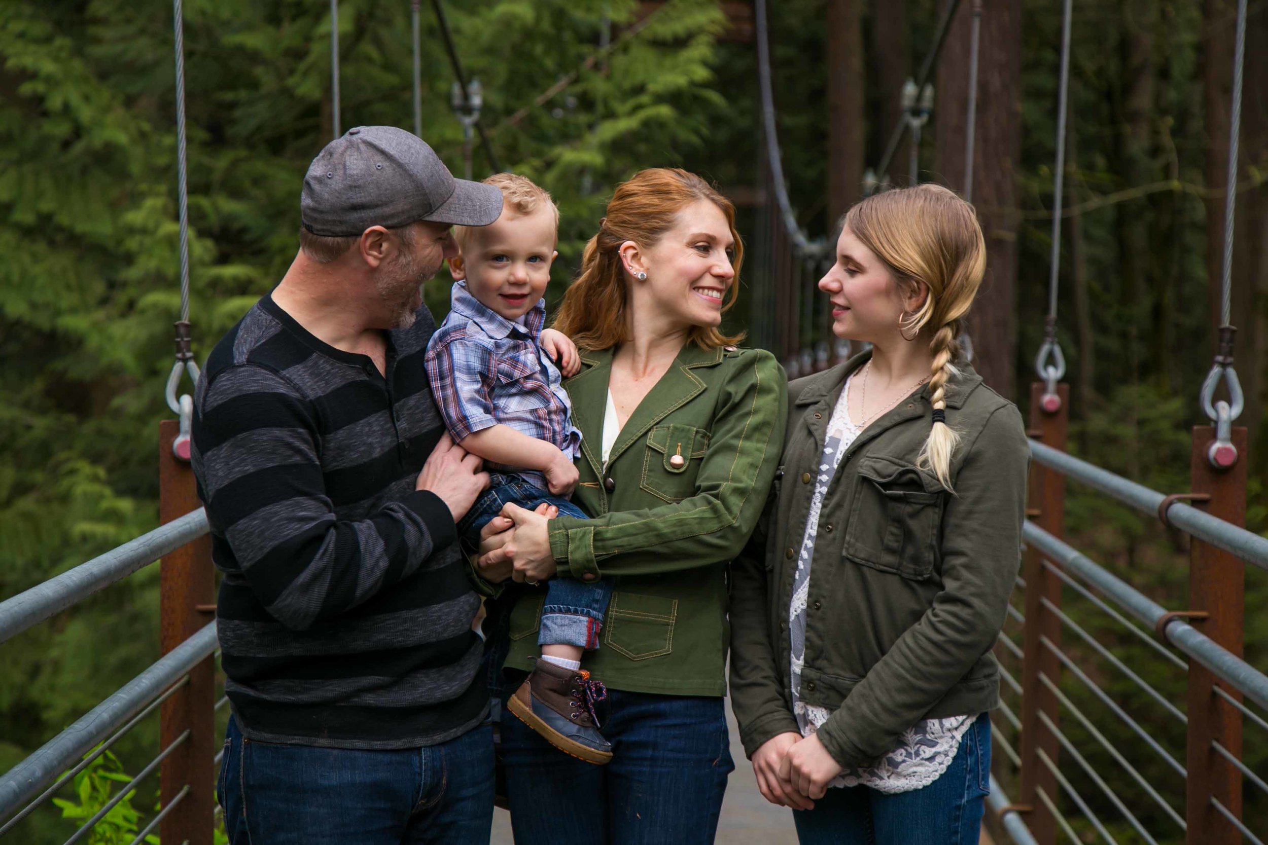 Seattle Family Photographer | G. Lin Photography | Family standing on bridge and looking at each other