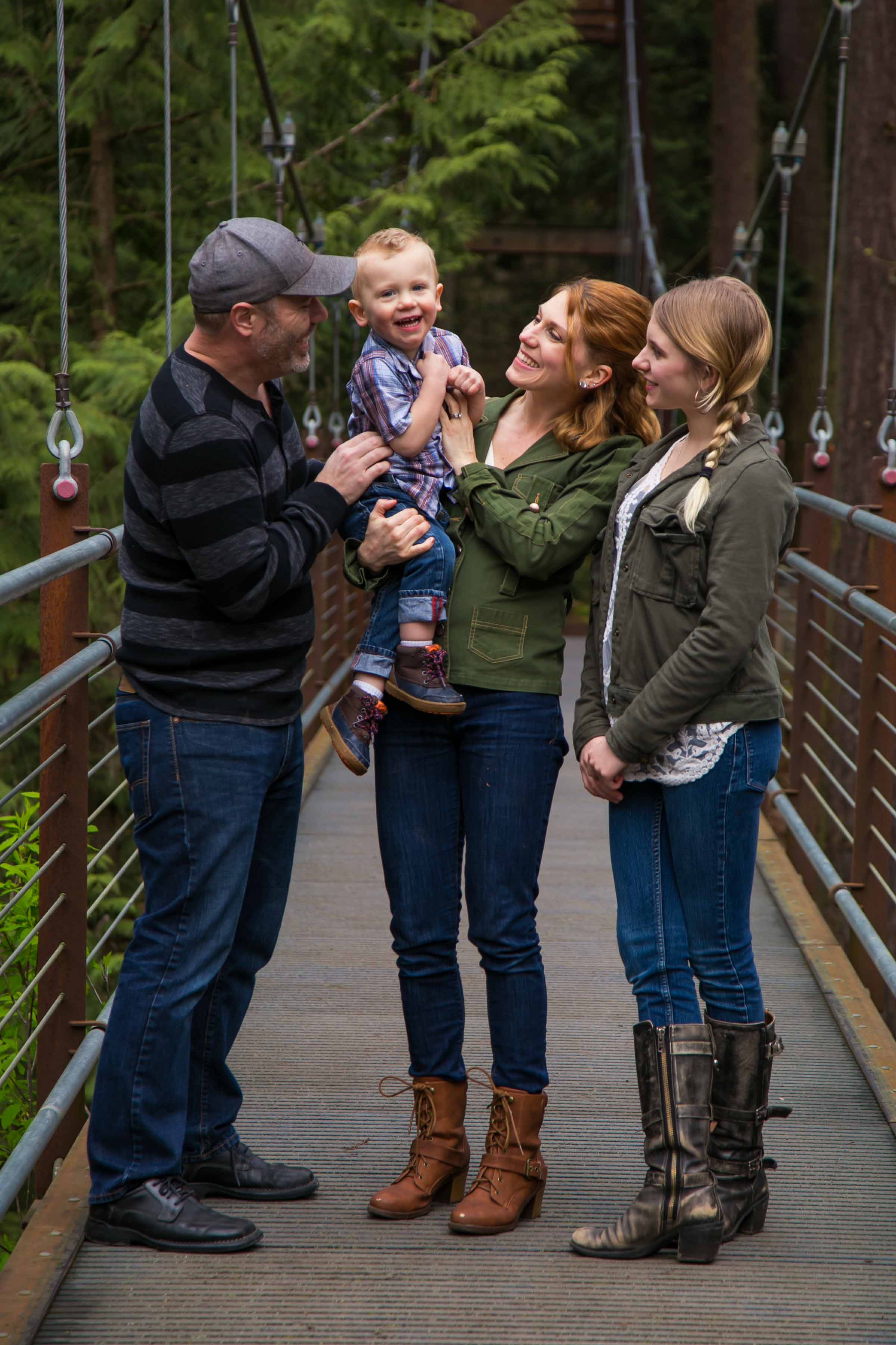 Seattle Family Photographer | G. Lin Photography | Family standing on bridge and tickling son
