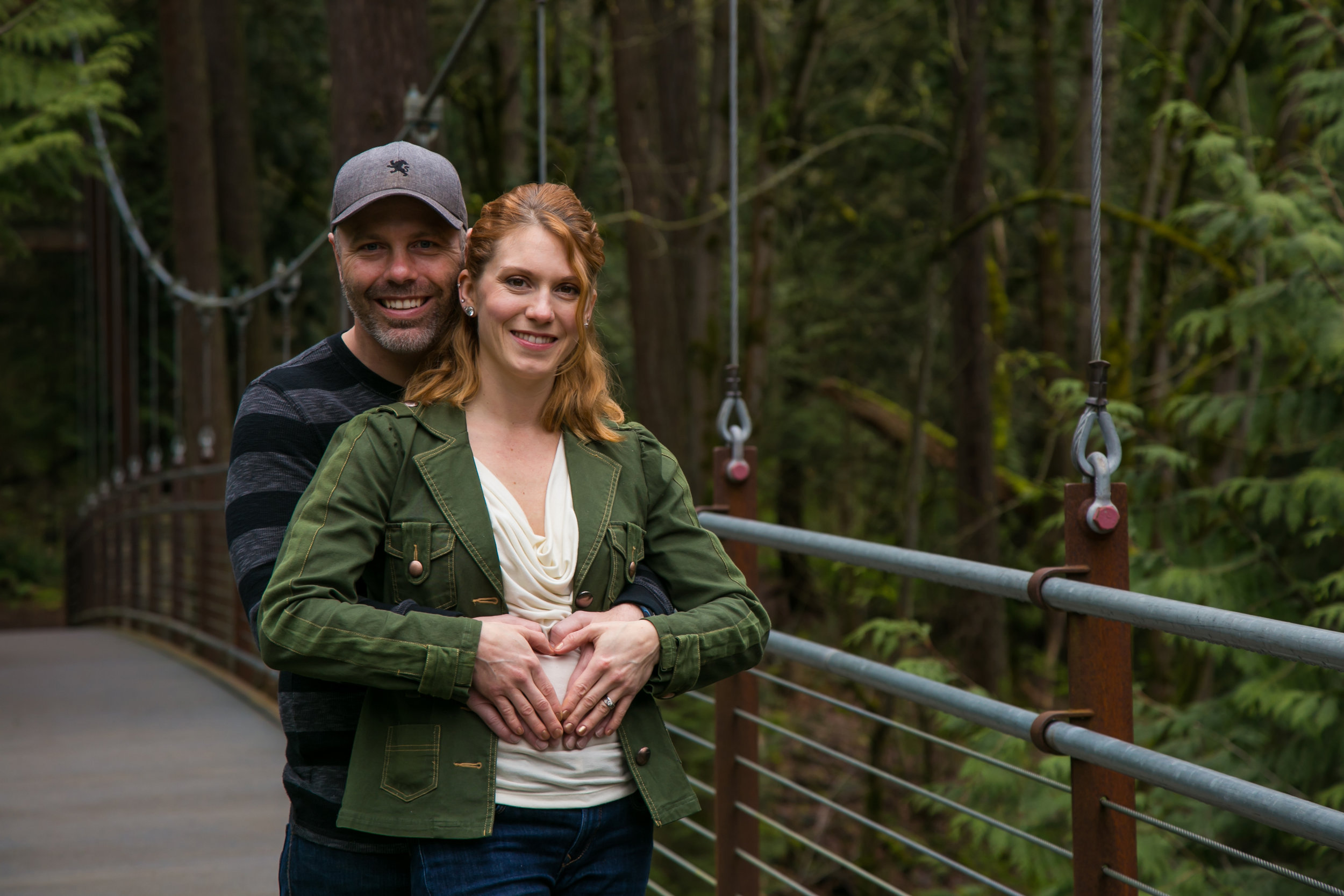 Seattle Family Photographer | G. Lin Photography | Couple standing on bridge smiling at camera