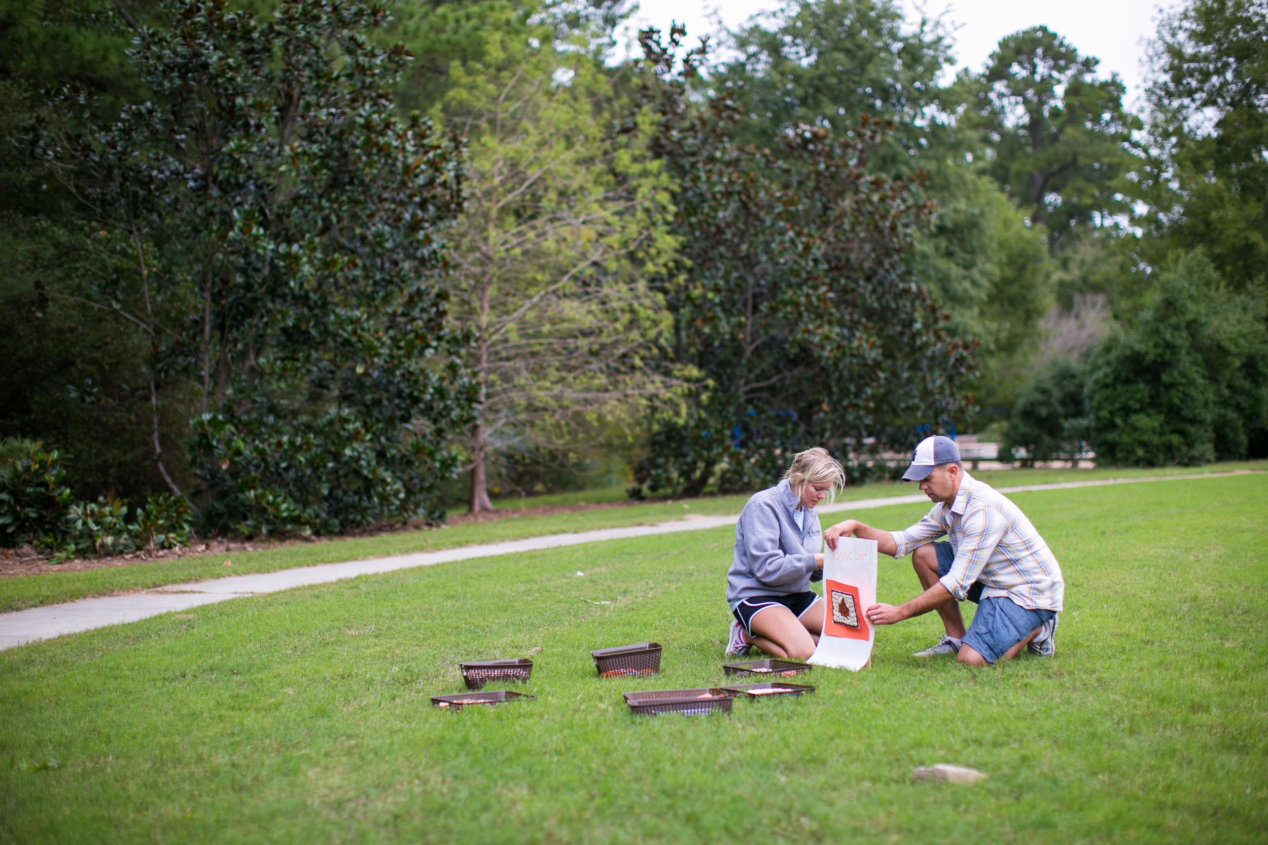 Raleigh Family Photographer | G. Lin Photography | Parents setting up booth on lawn