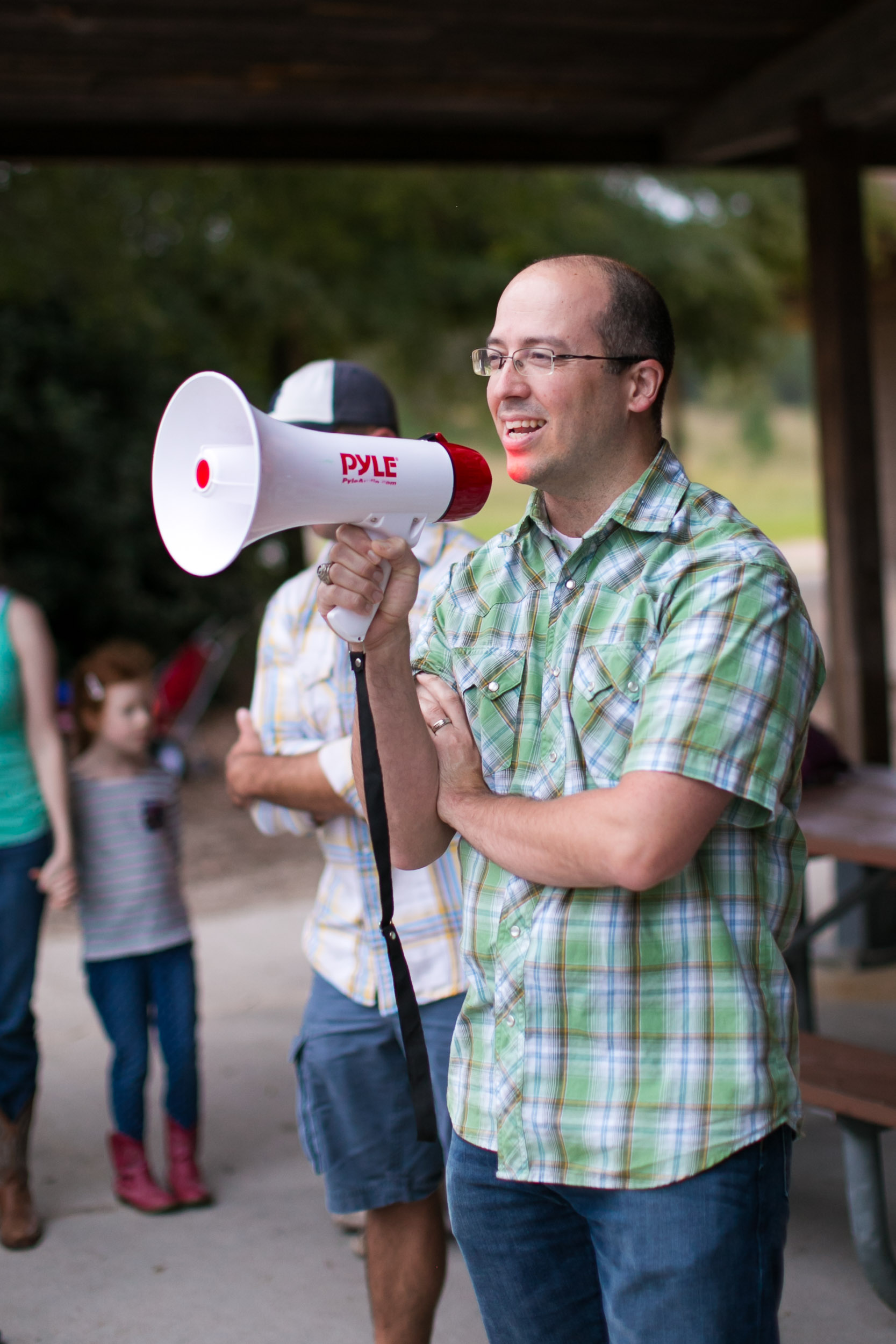 Raleigh Family Photographer | G. Lin Photography | Principal holding microphone and talking