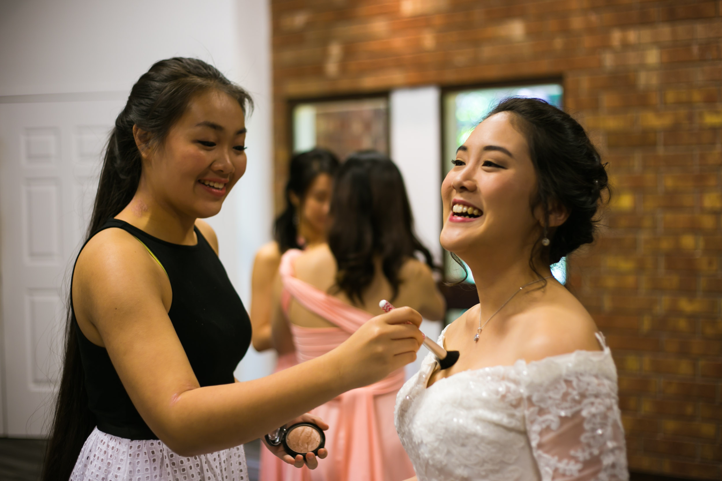 Campbell Lodge Wedding | Raleigh Wedding Photographer | G. Lin Photography | Bride smiling and getting ready with makeup artist