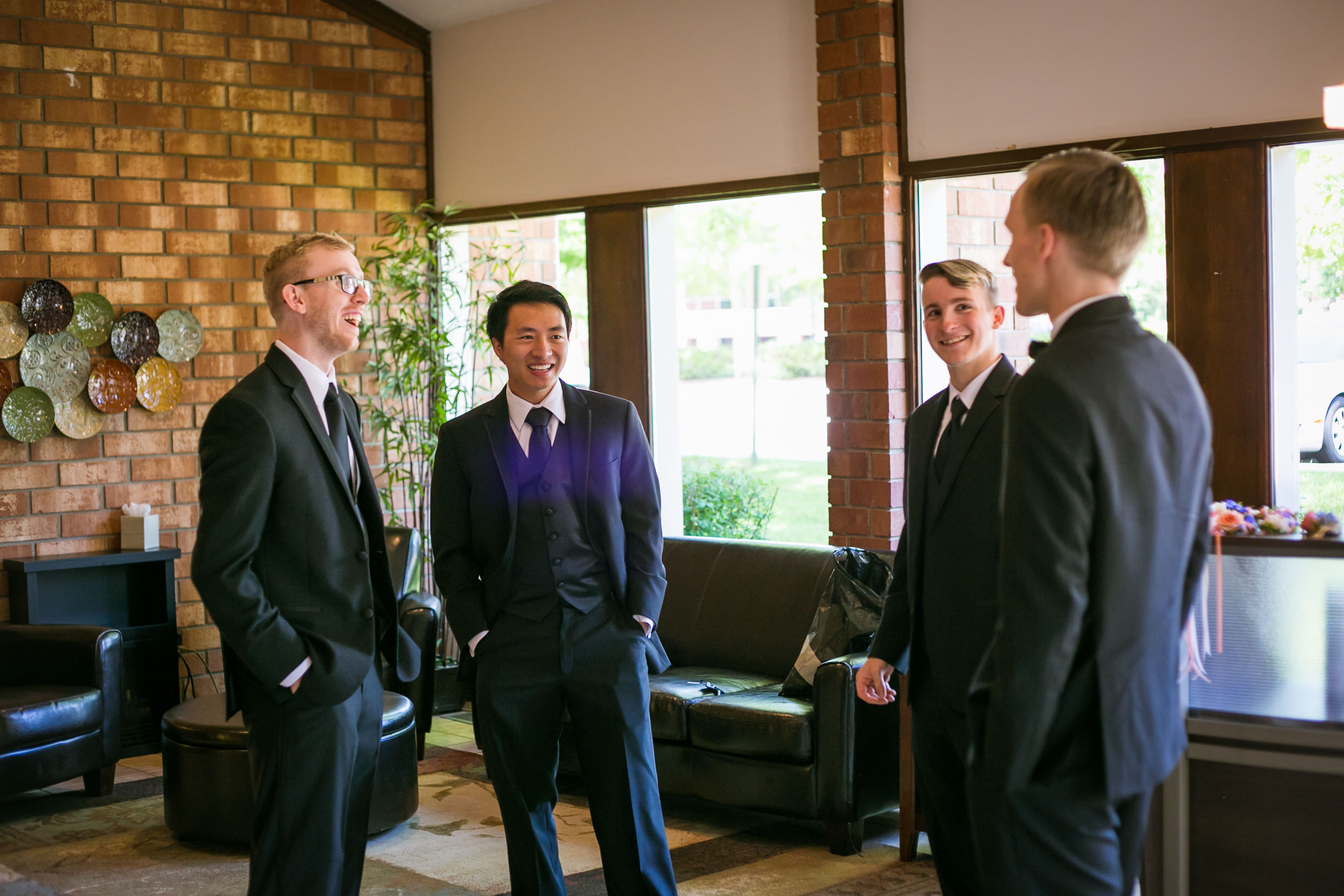 Raleigh Wedding Photographer | G. Lin Photography | Groomsmen standing in lobby and laughing