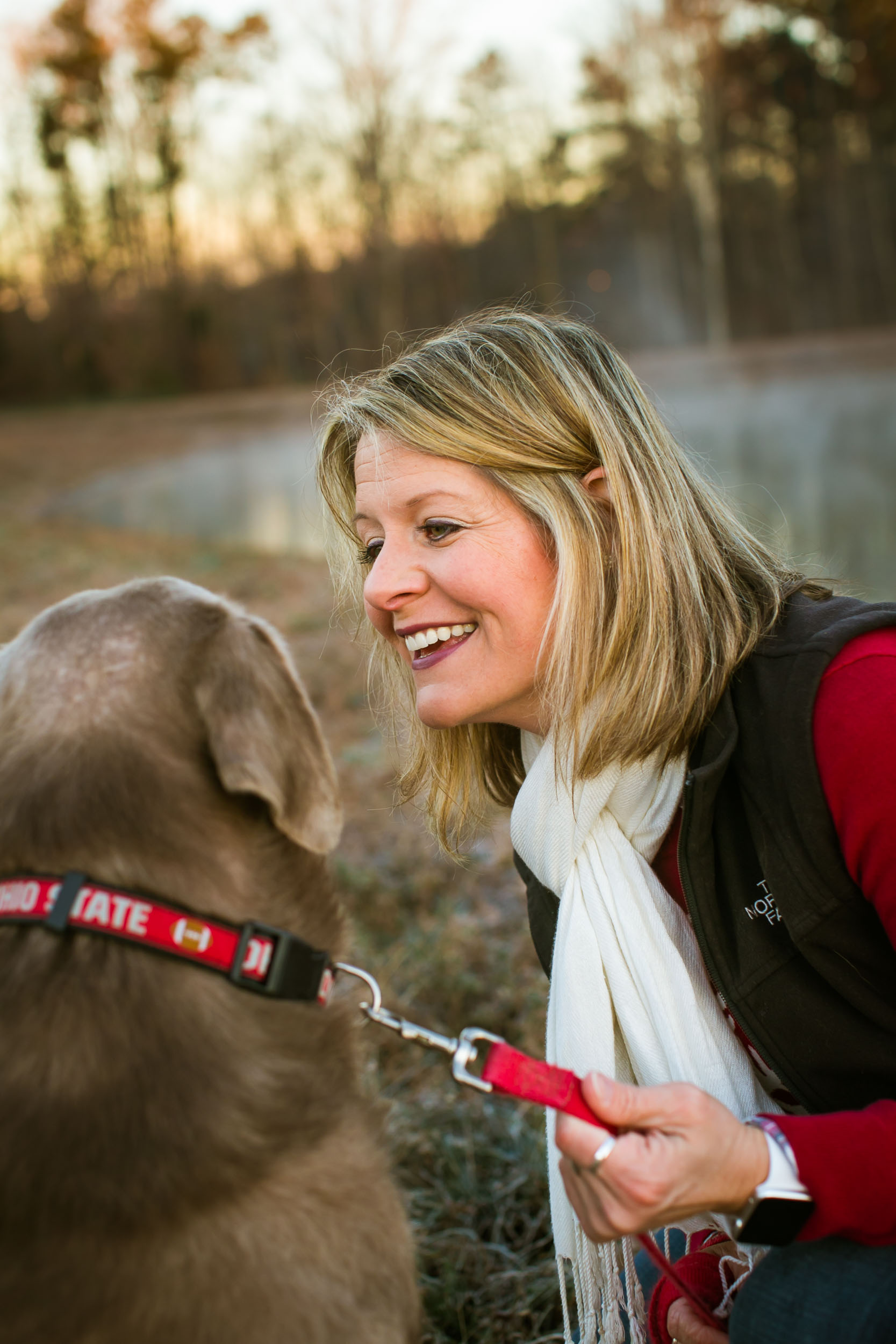 Durham Family Photographer | G. Lin Photography | Woman looking at dog and smiling at park