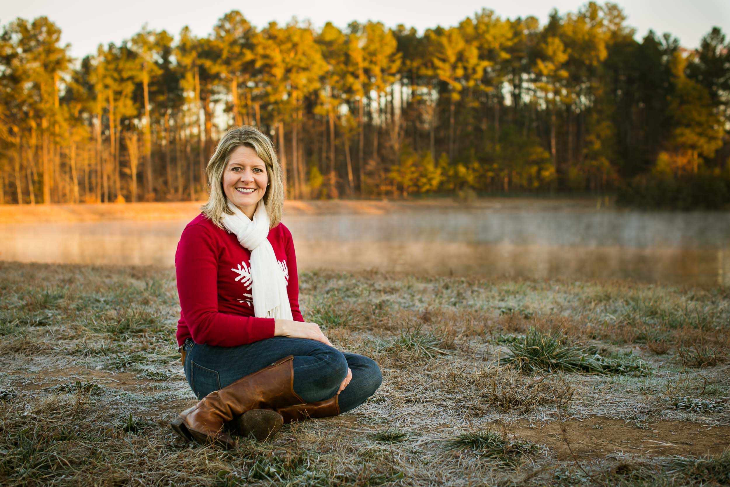 Durham Family Photographer | G. Lin Photography | Woman sitting by lake smiling at camera
