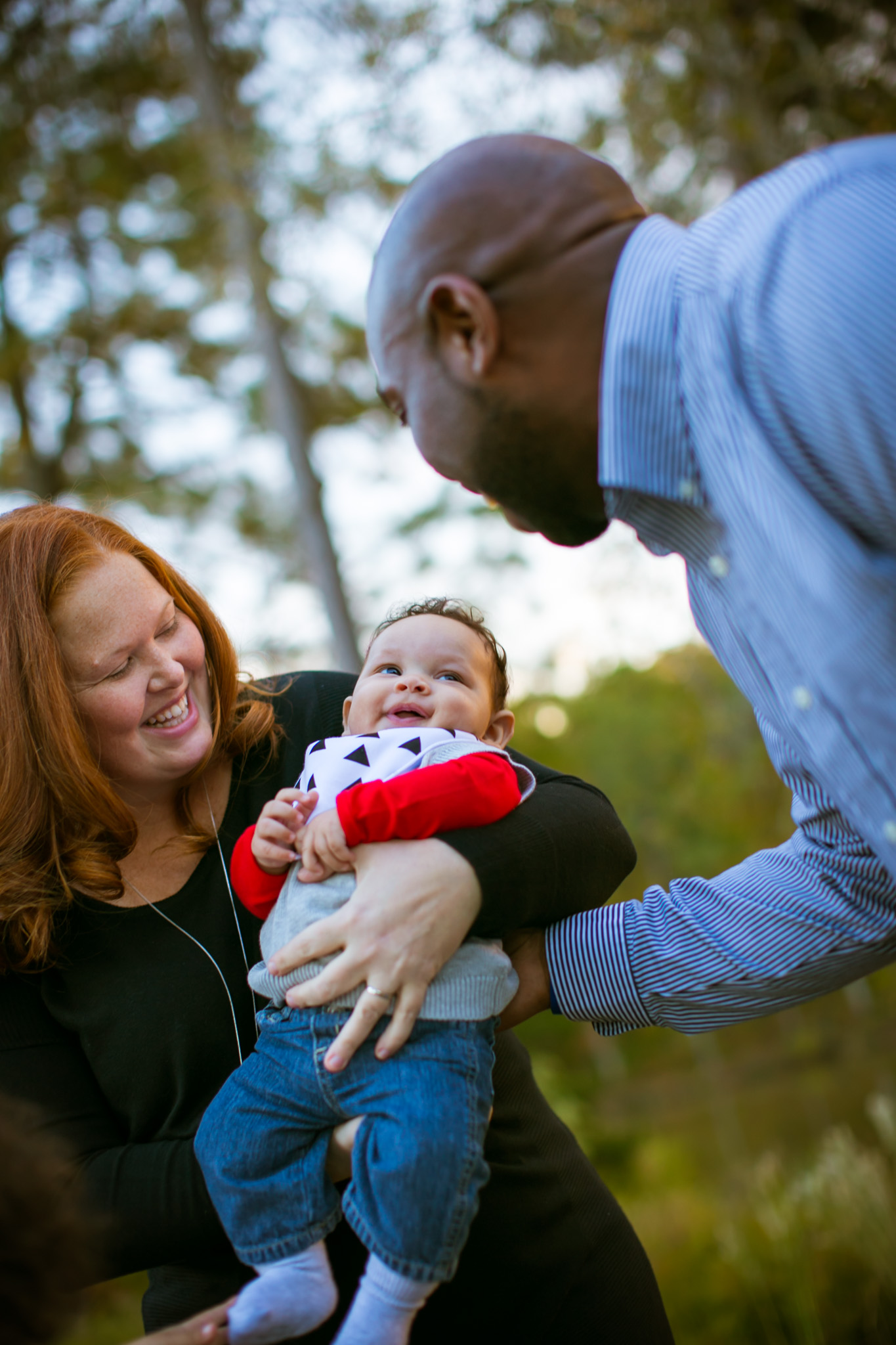 Durham Family Photographer | G. Lin Photography | Mother and father holding baby in Durham