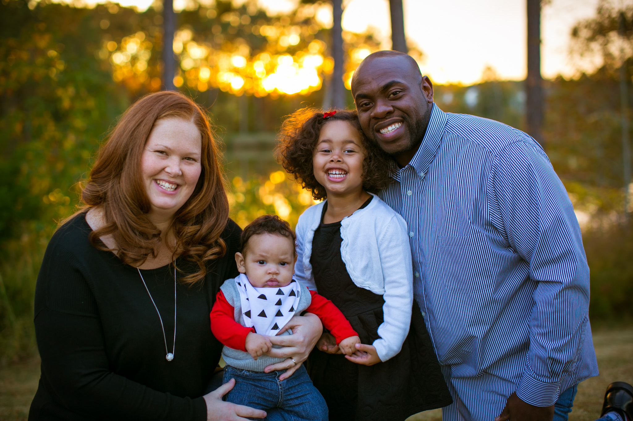 Durham Family Photographer | G. Lin Photography | Family sitting in front of lake and smiling
