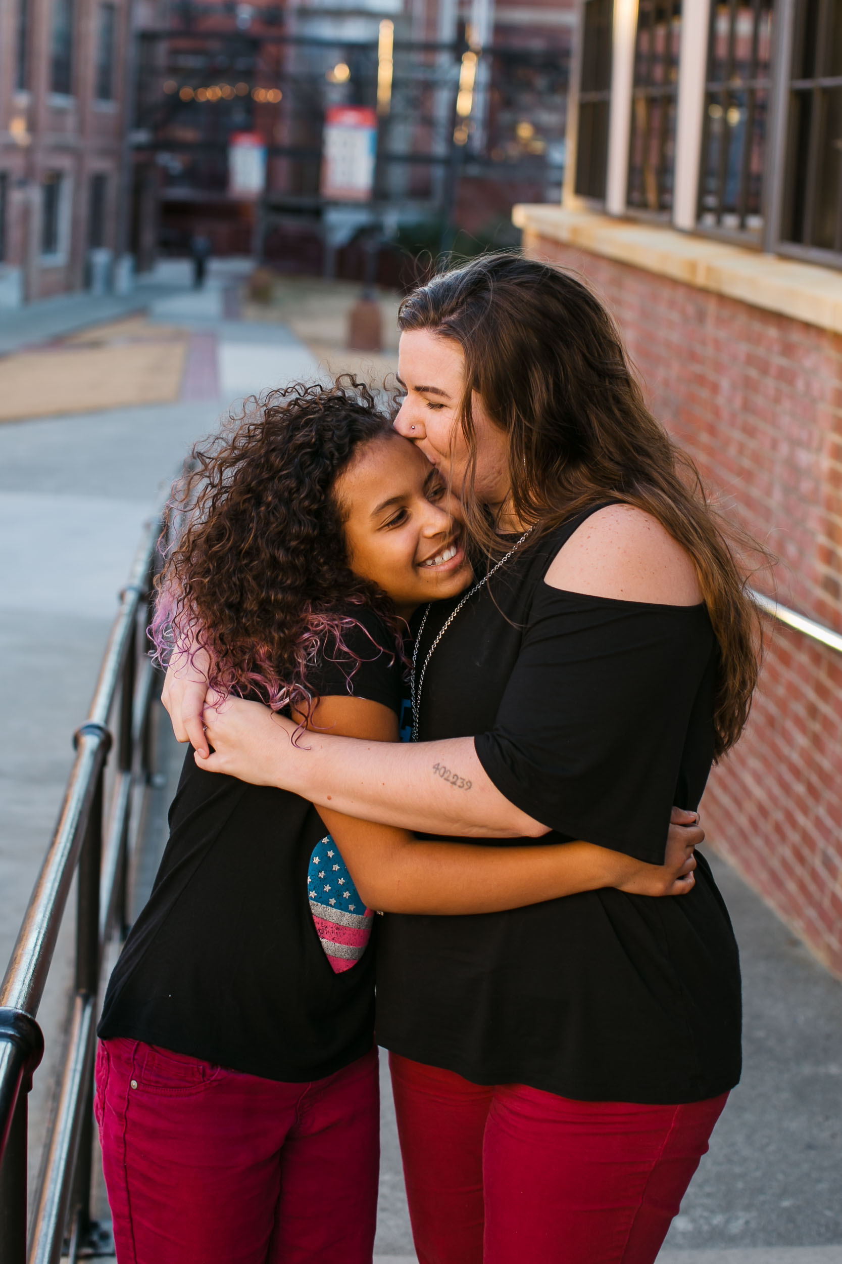 Durham Family Photographer | G. Lin Photography | Mother and daughter hugging at American Tobacco Campus