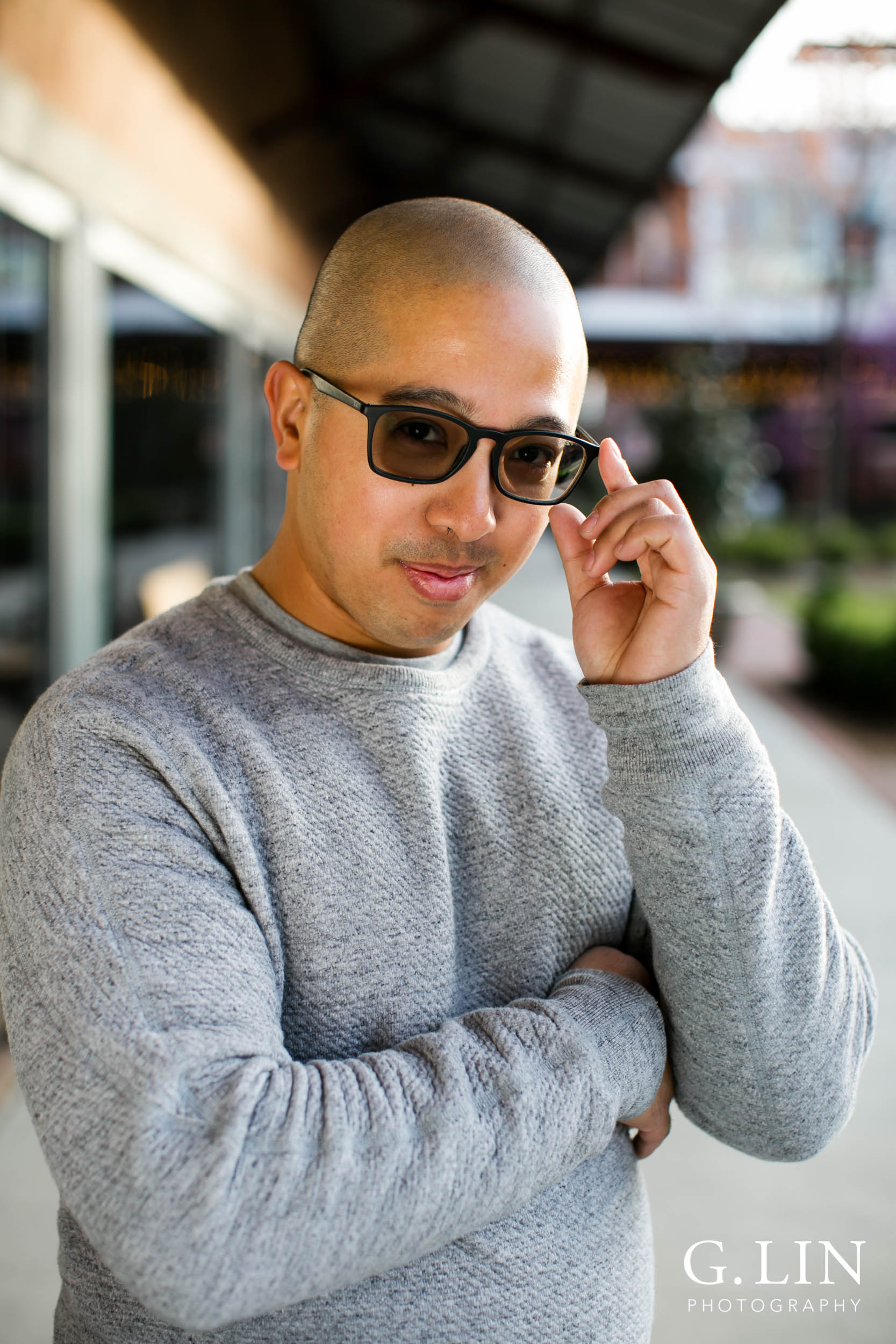 Durham Family Photographer | G. Lin Photography | Man in front of store holding sunglasses