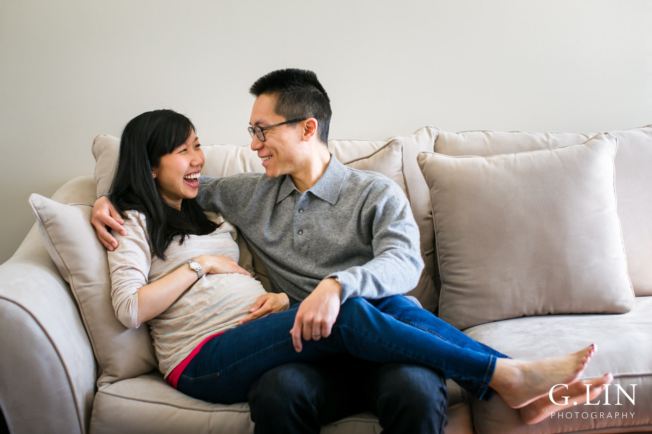 Durham Maternity Photography | G. Lin Photography | Couple sitting on couch and laughing