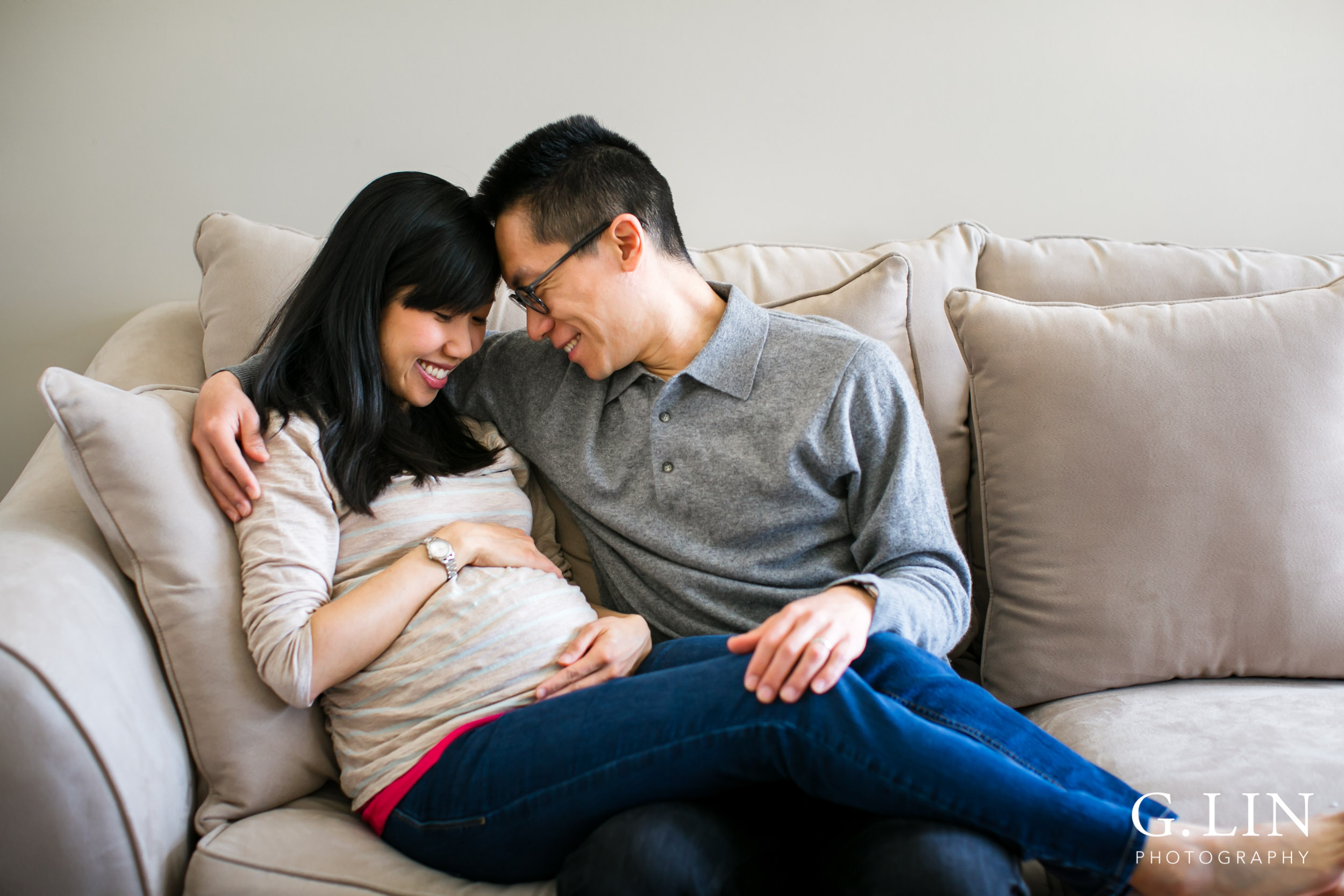 Durham Maternity Photography | G. Lin Photography | Couple sitting on couch and smiling