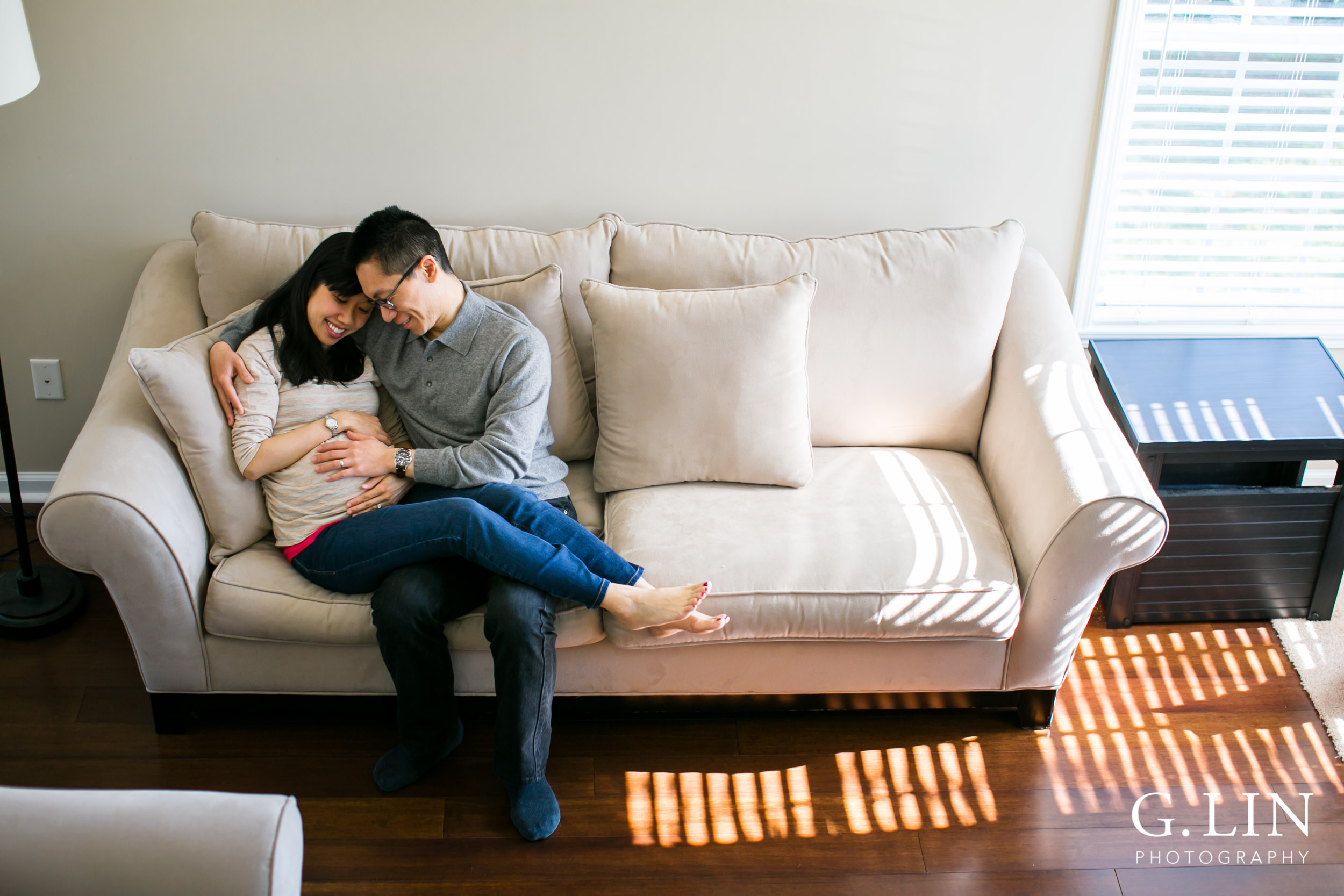 Durham Maternity Photography | G. Lin Photography | Wide shot of couple sitting on couch