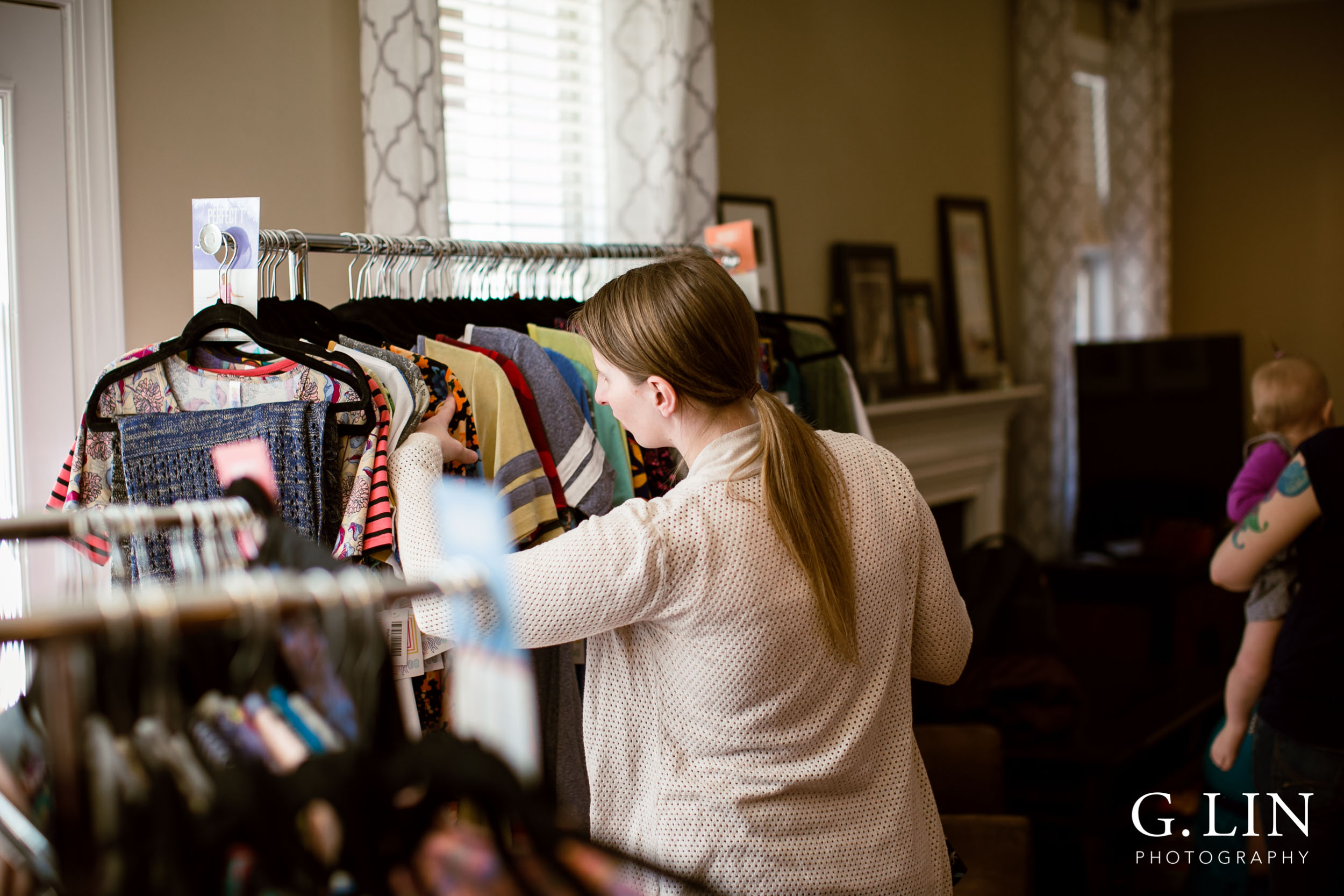 Raleigh Event Photographer | G. Lin Photography | Woman browsing clothing selection inside home