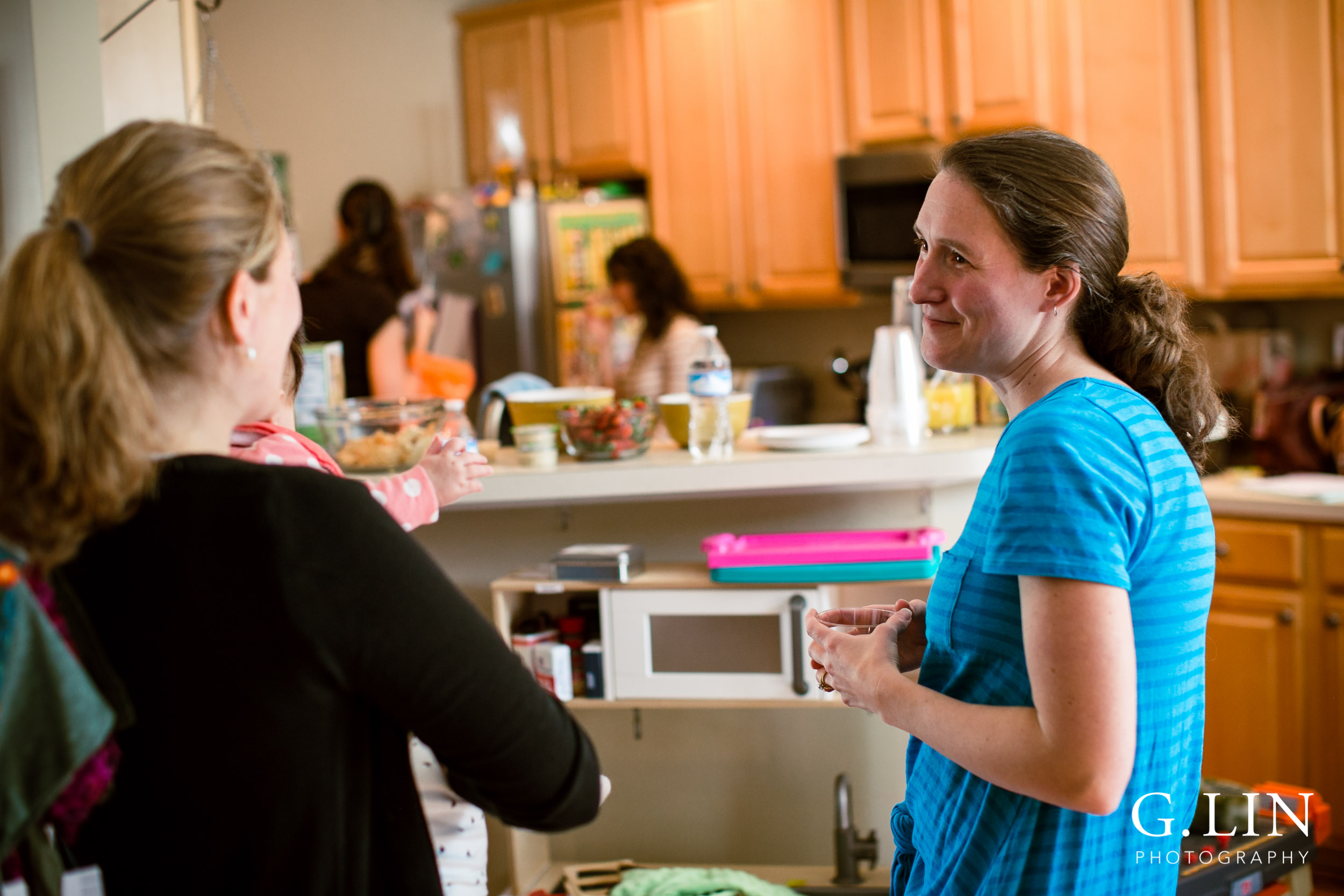 Raleigh Event Photographer | G. Lin Photography | Woman talking to another woman inside kitchen