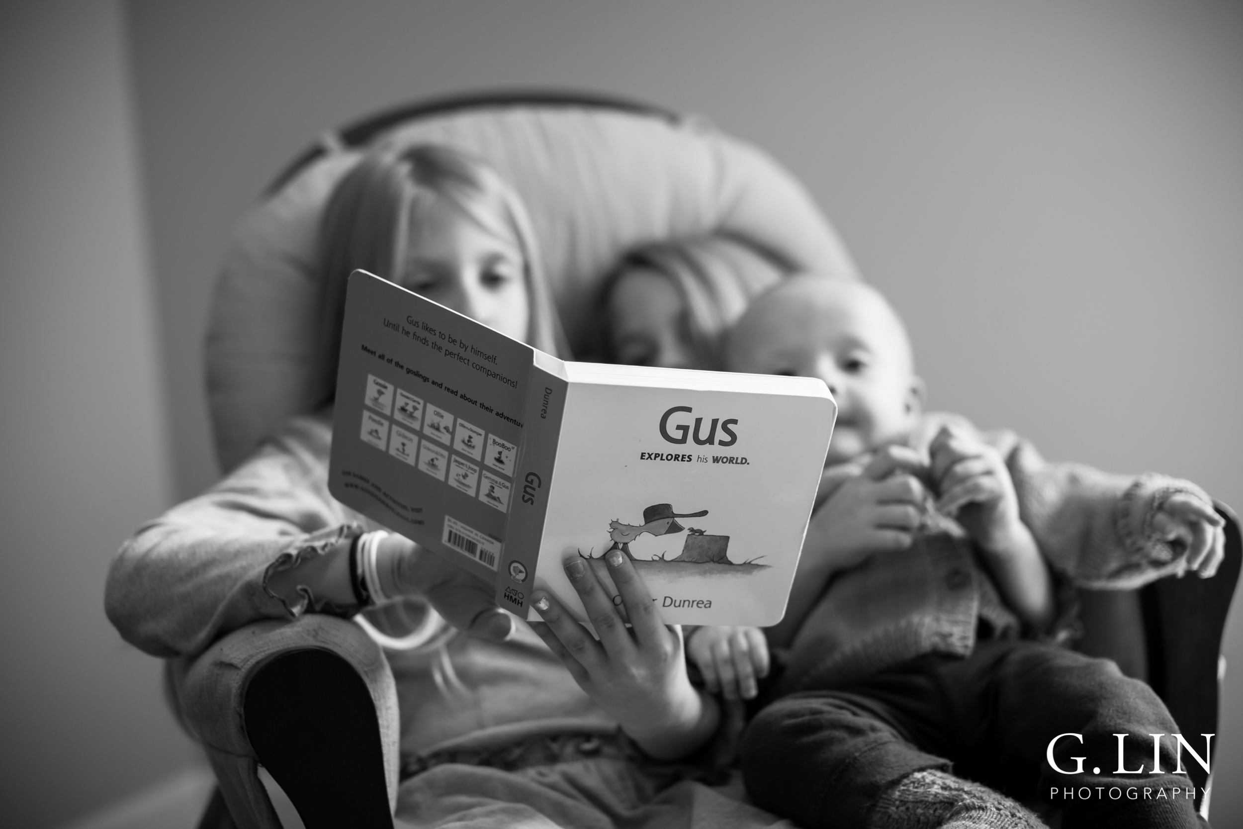 Raleigh Family Photographer | G. Lin Photography | Children sitting on chair and reading to little brother