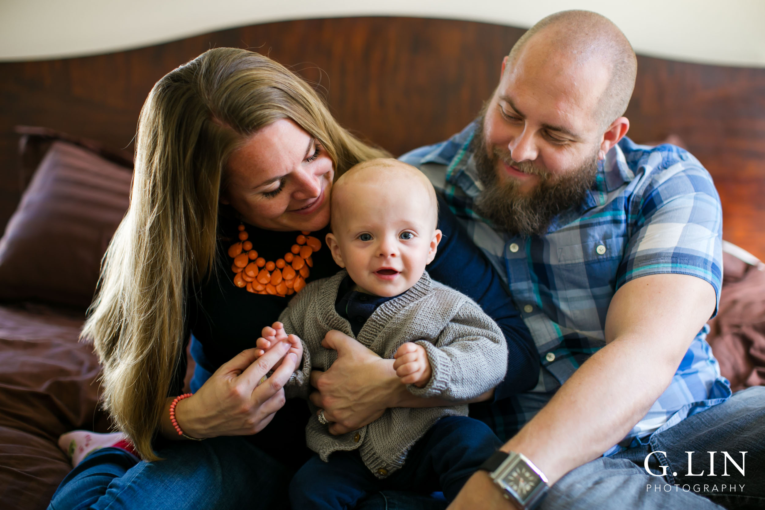 parents posing with baby