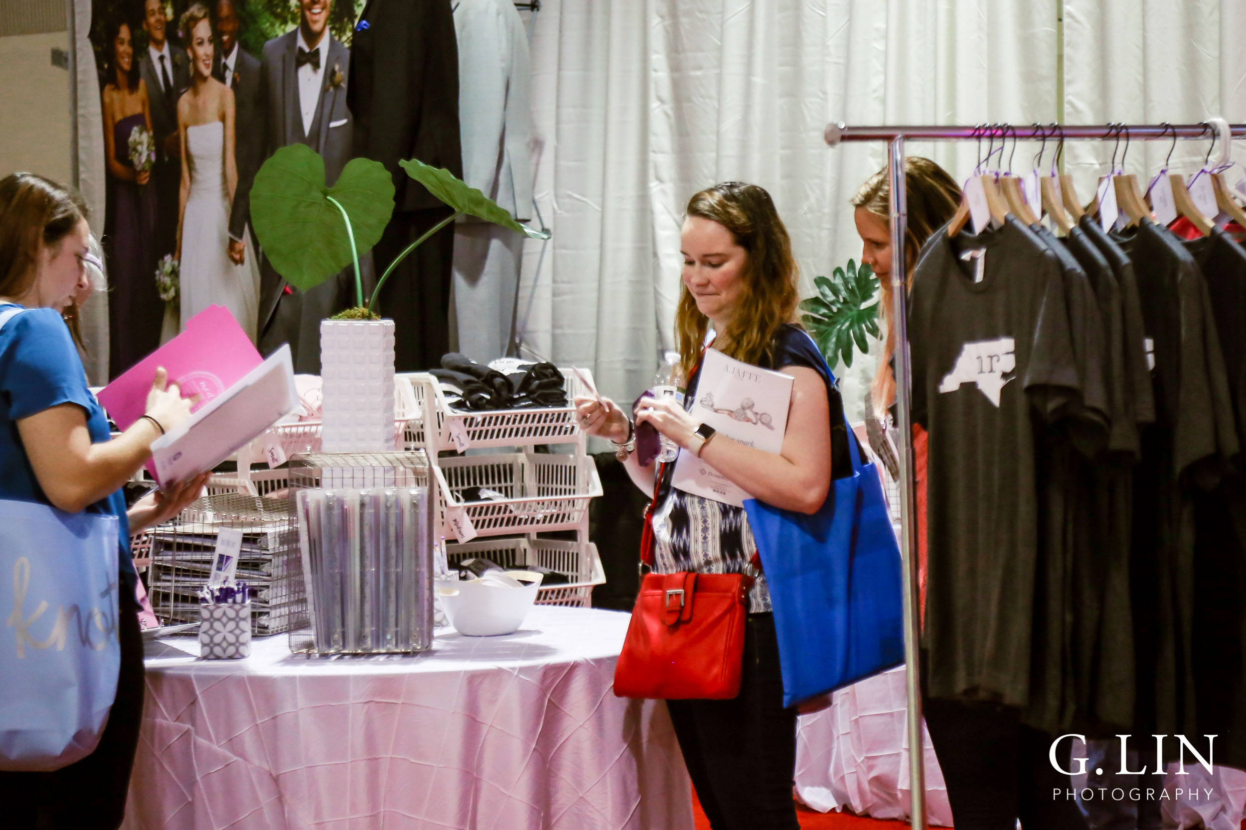 Raleigh Event Photographer | G. Lin Photography | Guests at booth looking at wedding merchandise
