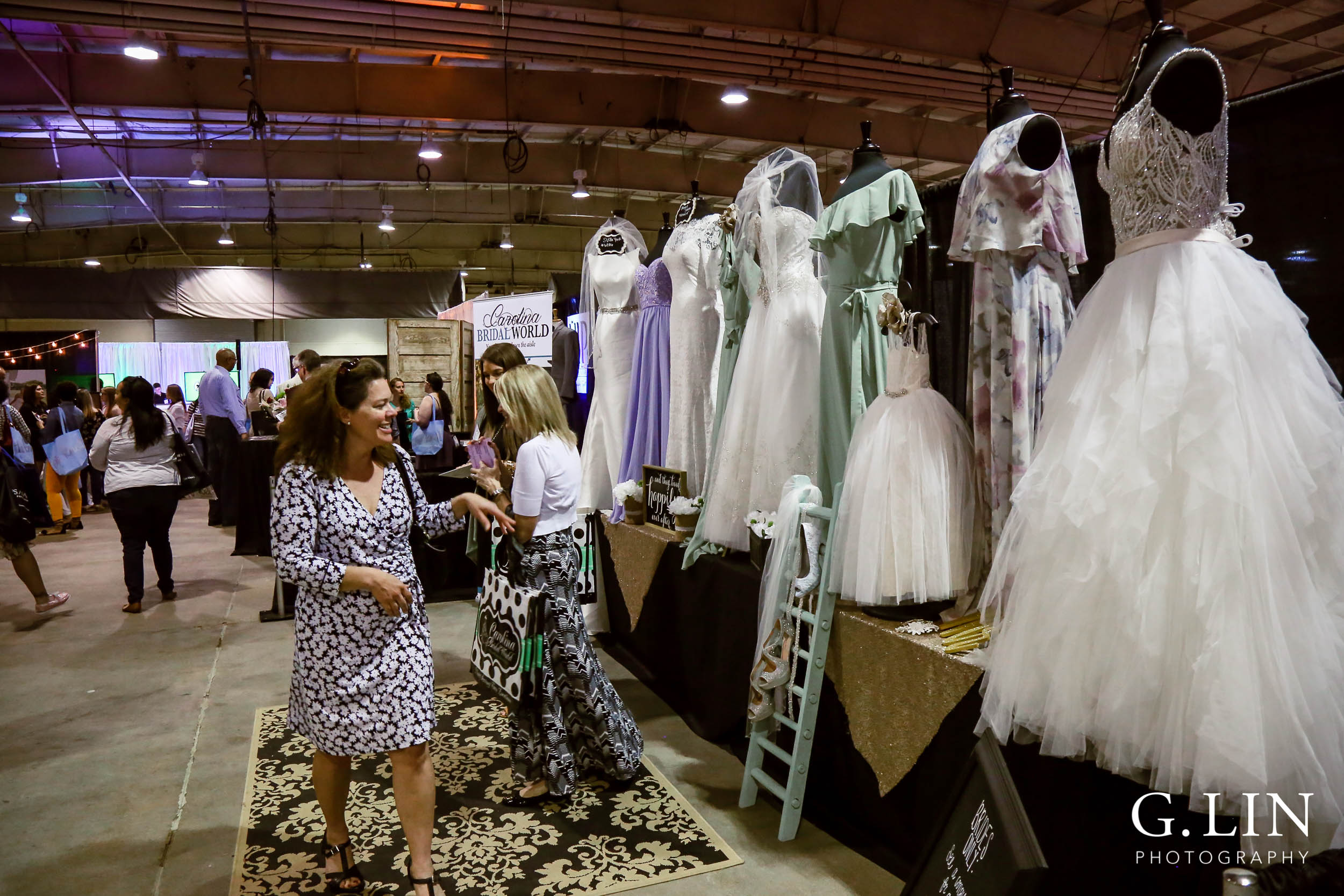 Raleigh Event Photographer | G. Lin Photography | Guest looking at wedding dresses at bridal show