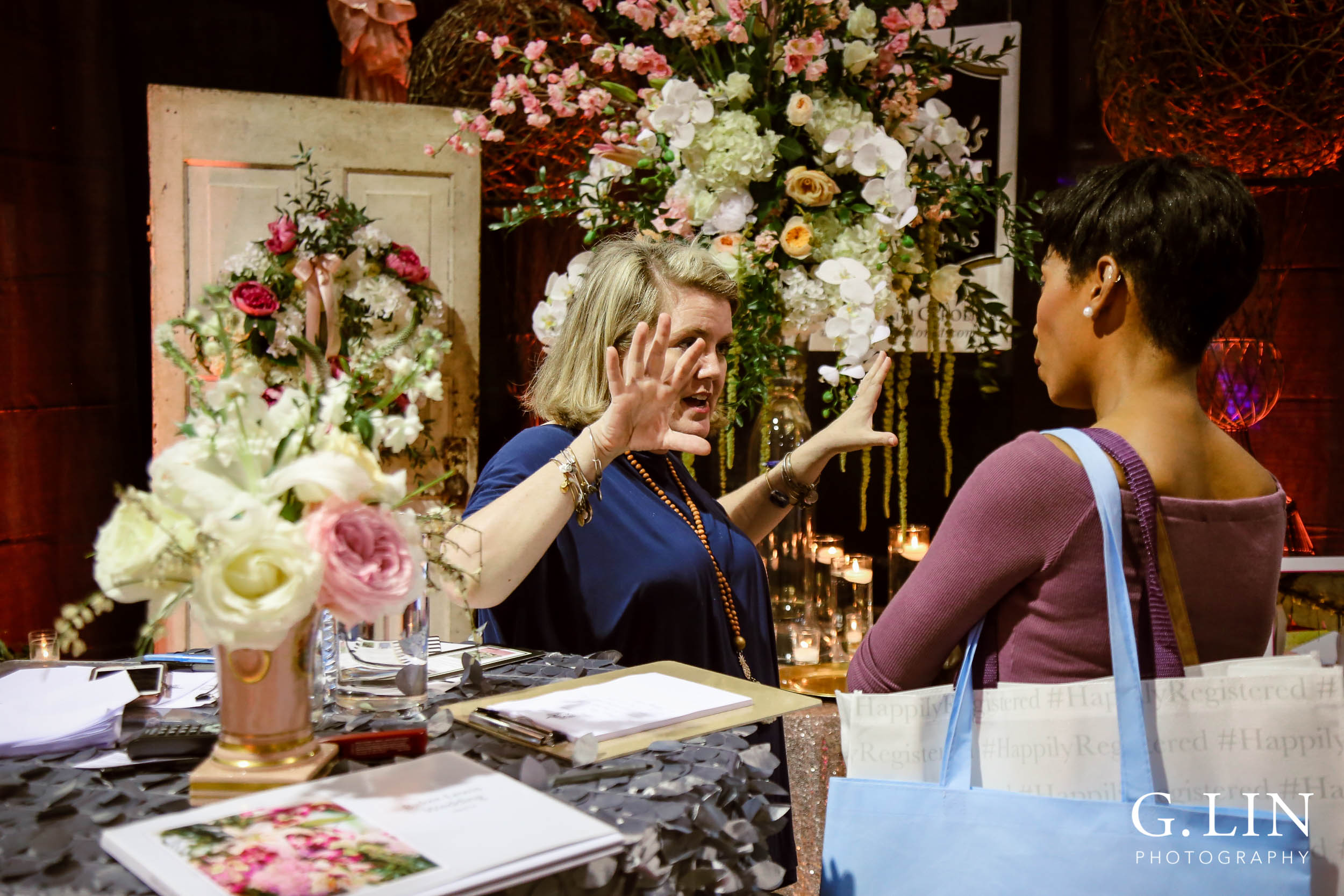 Raleigh Event Photographer | G. Lin Photography | Woman and bride talking to each other at booth