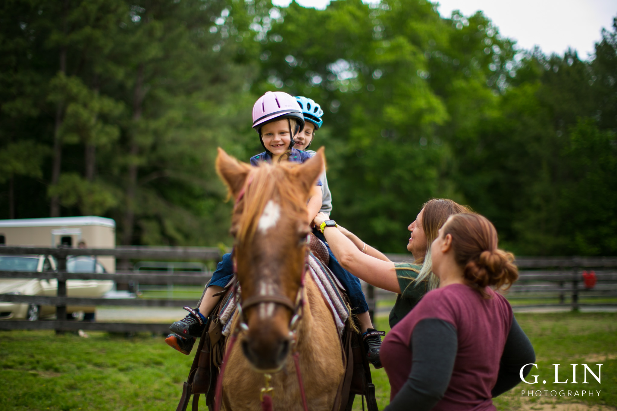 G. Lin Photography | Raleigh Event Photographer | Two boys on horse riding around the field