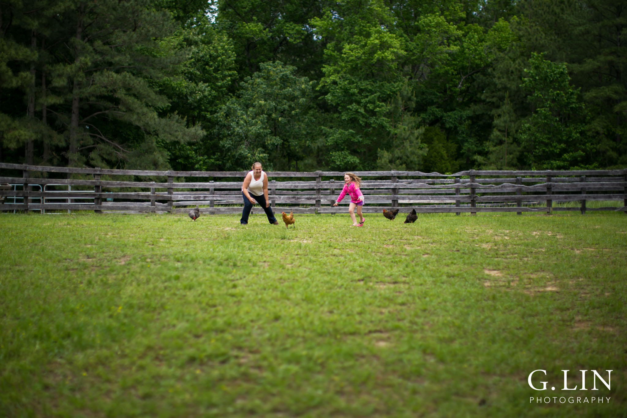 G. Lin Photography | Raleigh Event Photographer | Woman and girl on farm chasing chickens