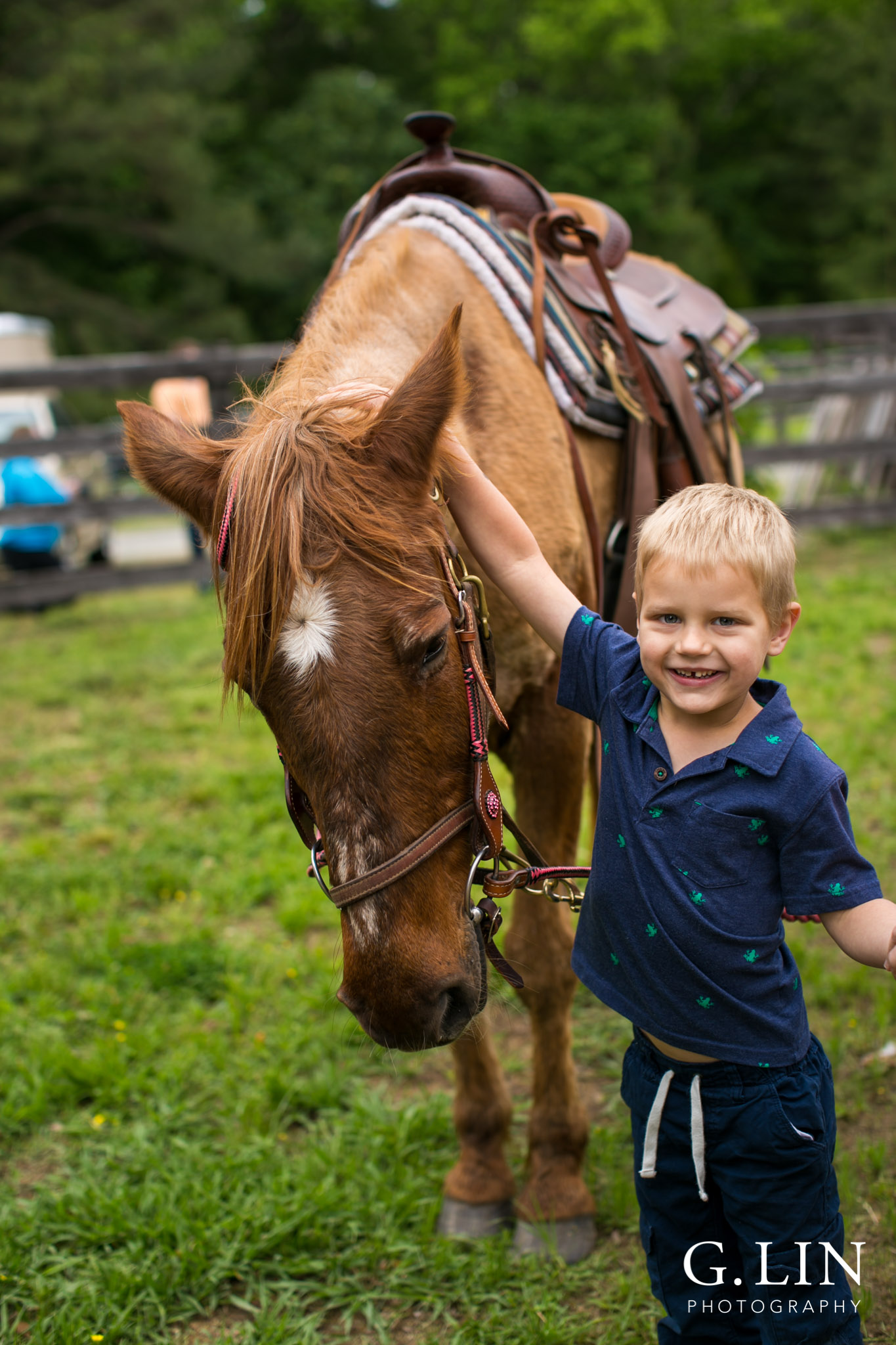 G. Lin Photography | Raleigh Event Photographer | Boy standing next to horse and smiling at camera