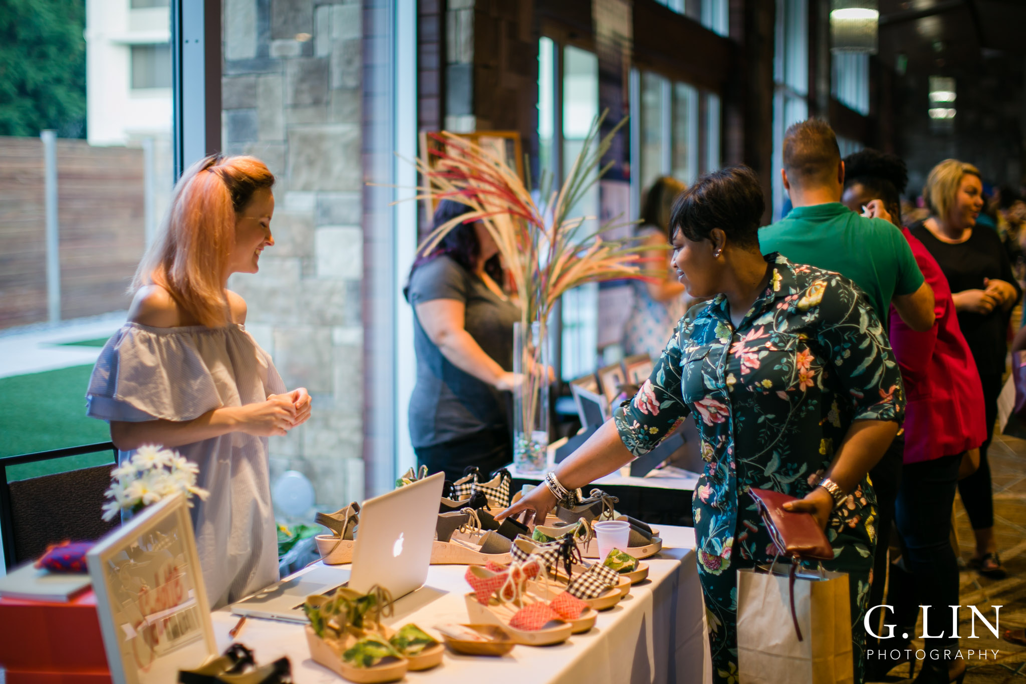 Raleigh Event Photographer | G. Lin Photography | Women browsing at shoes inside hotel