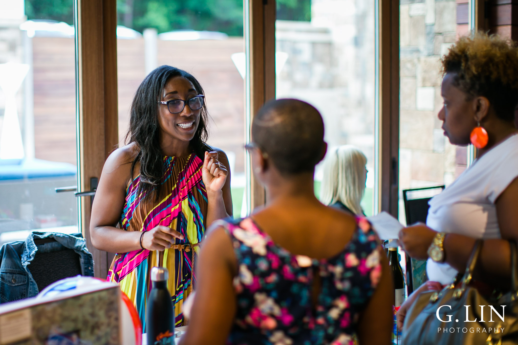 Raleigh Event Photographer | G. Lin Photography | Woman standing at table and providing advice to guests