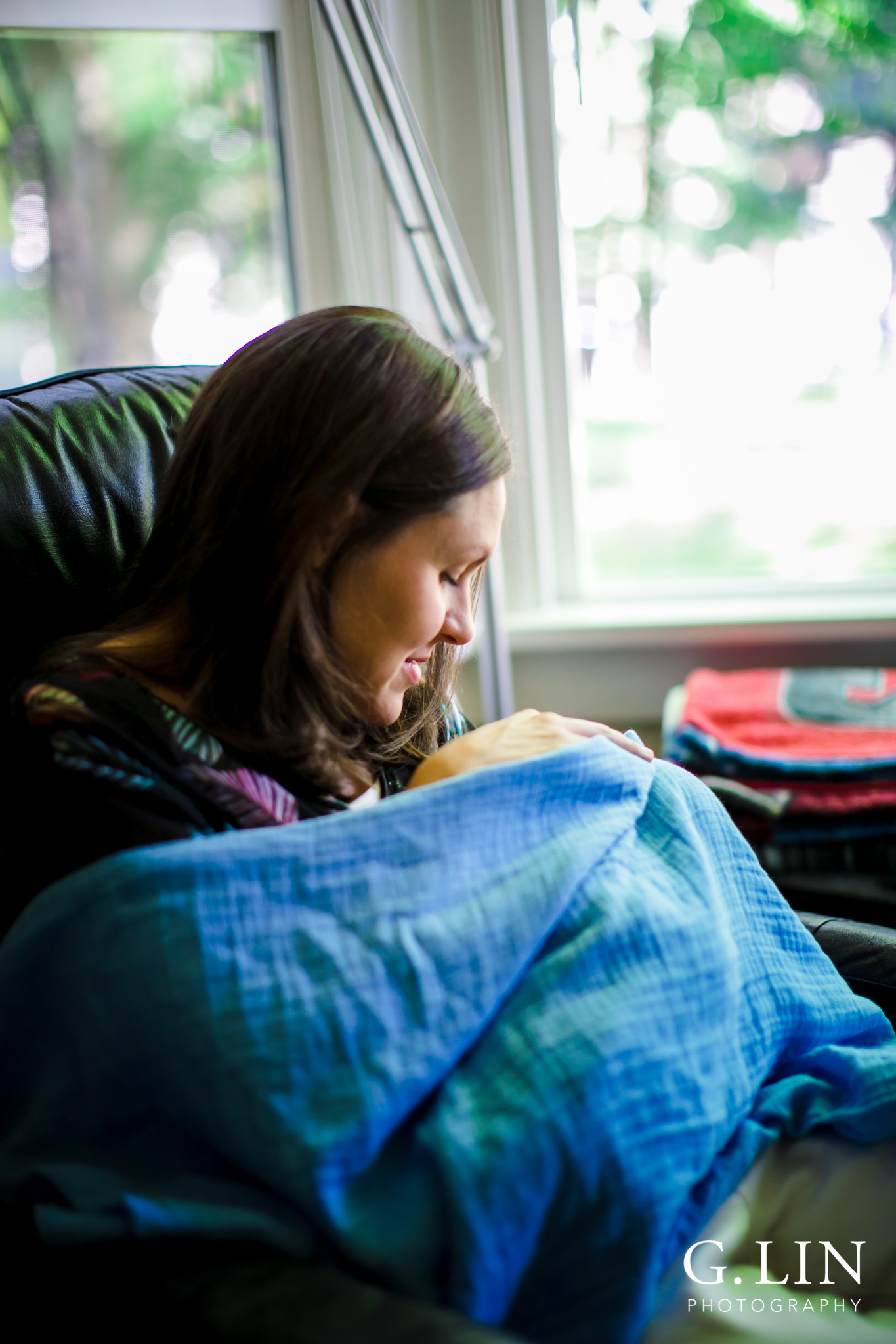 Raleigh Family Photographer | G. Lin Photography | Mother sitting on chair and feeding baby