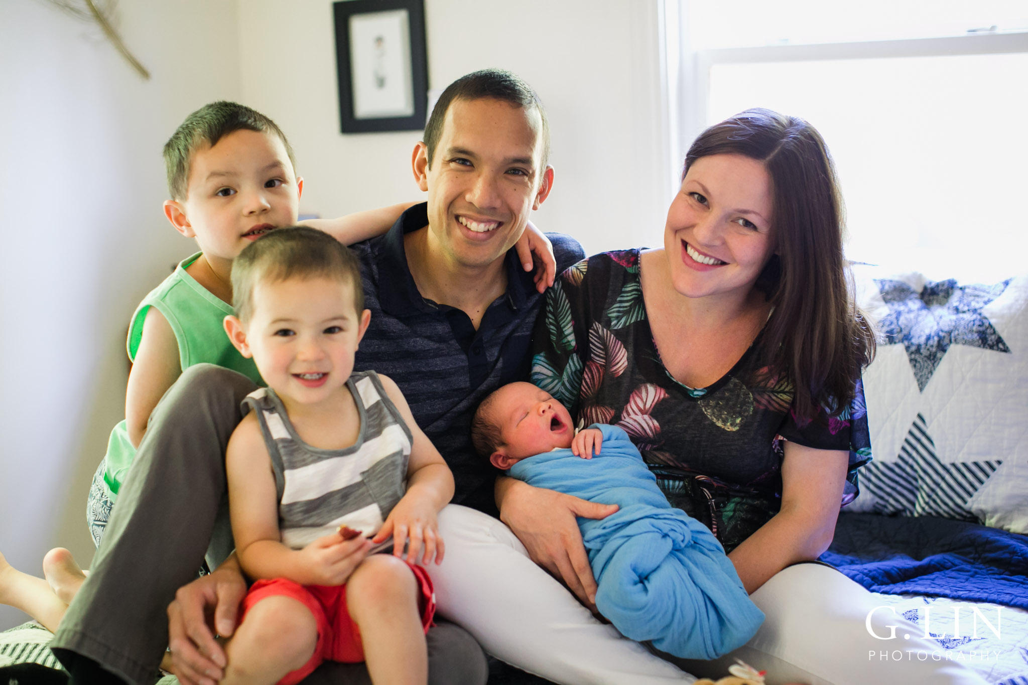 Raleigh Family Photographer | G. Lin Photography | Family sitting on bed and smiling