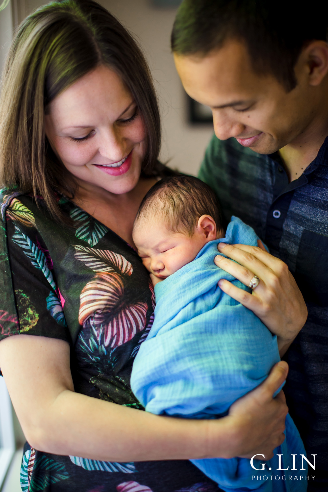 Raleigh Family Photographer | G. Lin Photography | Mother and father holding baby in bedroom